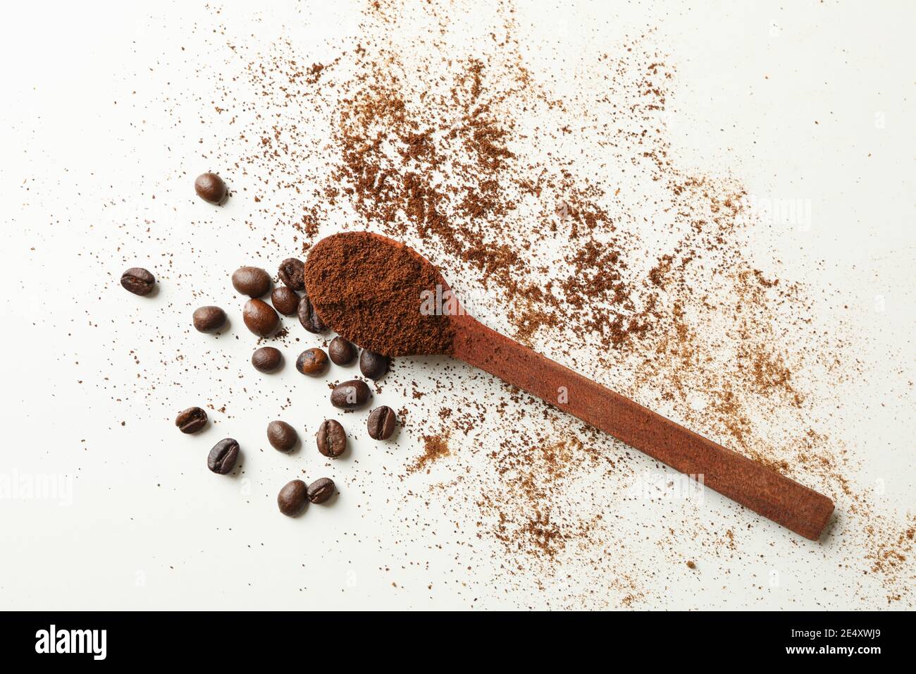 Spoon with ground coffee and beans on white background Stock Photo - Alamy