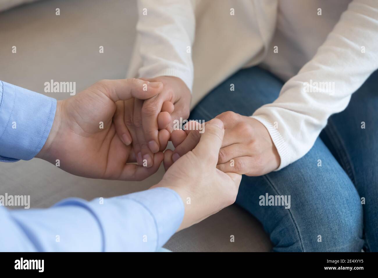 Close up loving husband holding wife hands, supporting and comforting Stock Photo