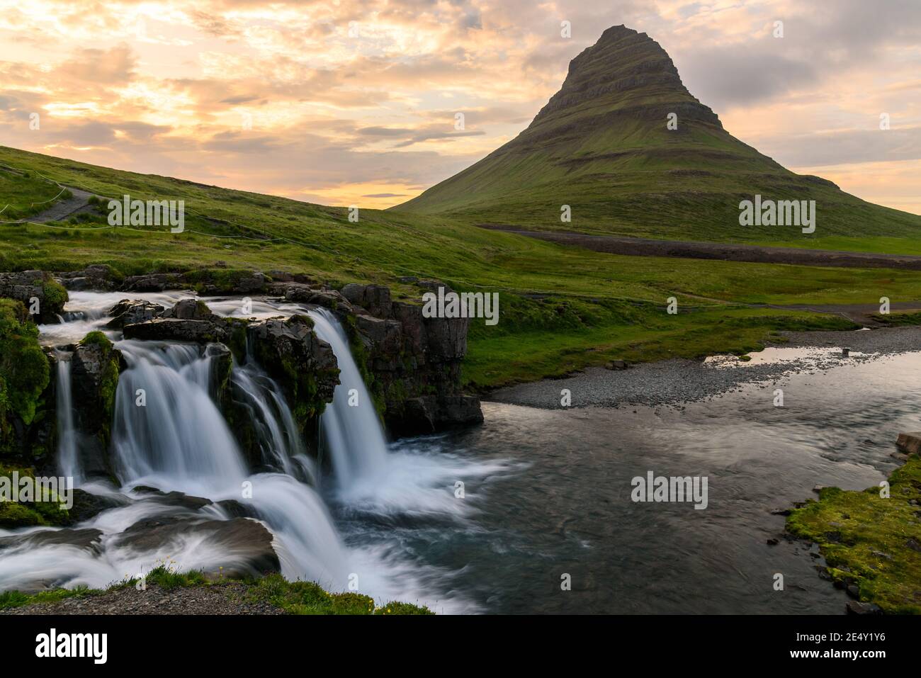 Beautiful Kirkjufell mountain with waterfall in foreground at sunset in summer Stock Photo