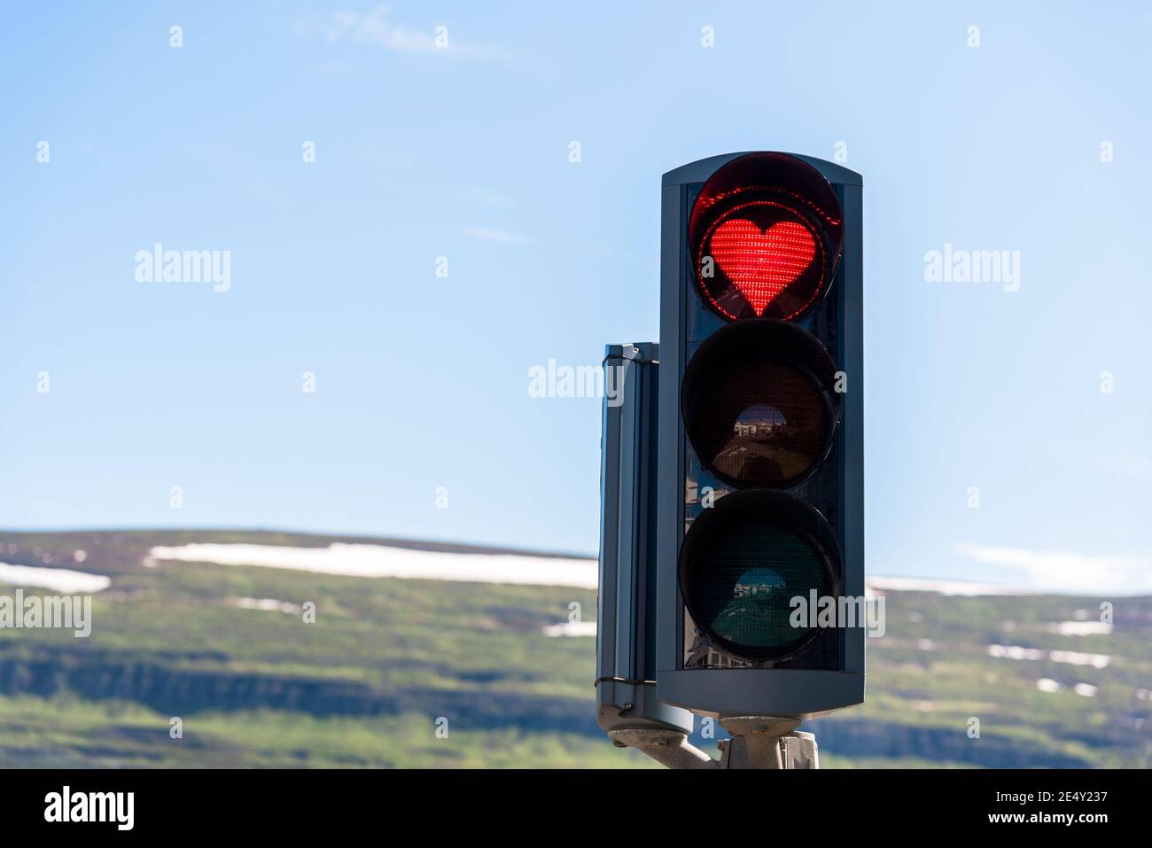 Traffic lights with a red heart-shaped signal Stock Photo