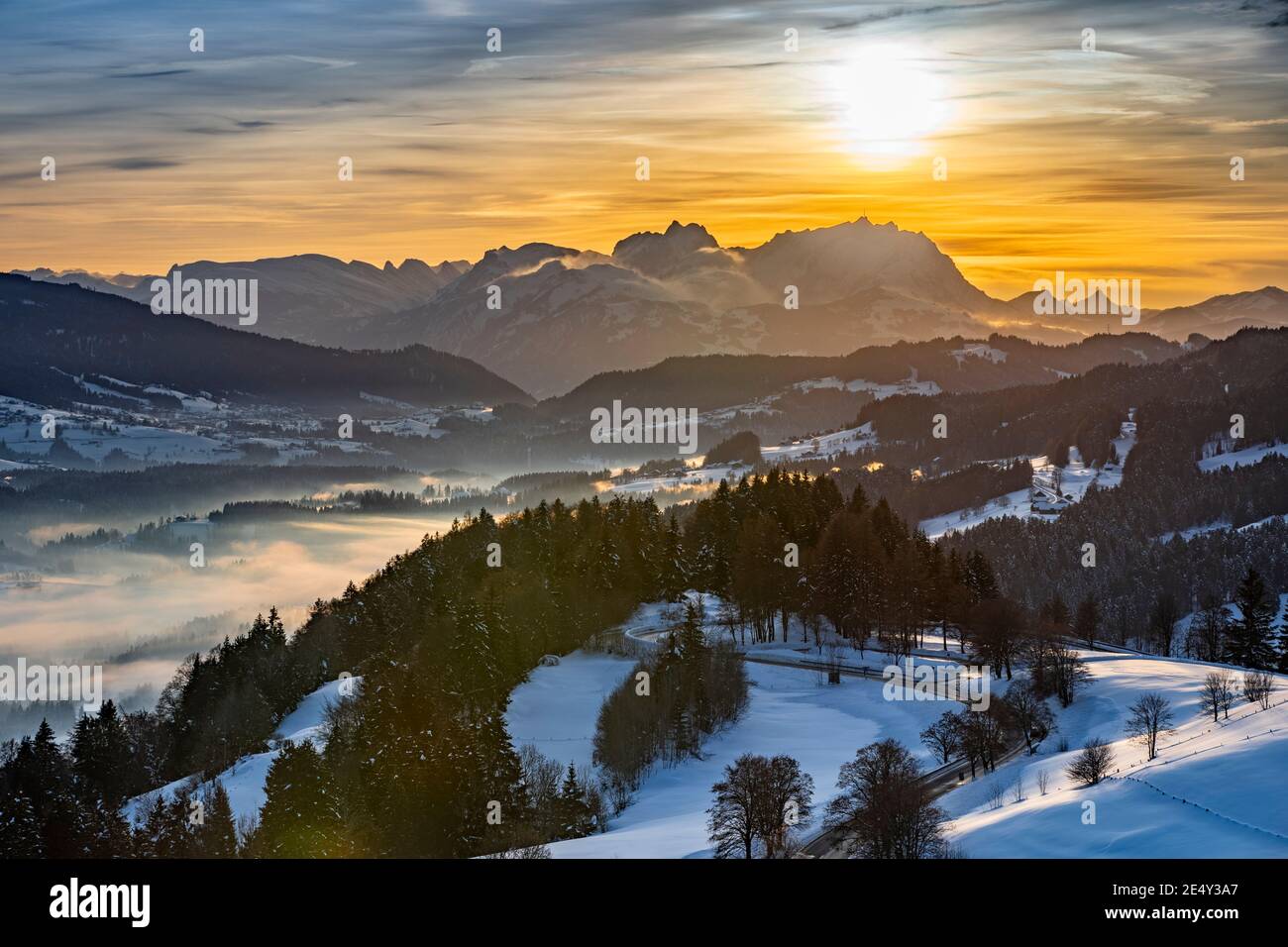 awesome winter landscape at sunset with  view from the Allgau Alps over the Bregenzer Wald in Austria to Mount Saentis in Switzerland Stock Photo
