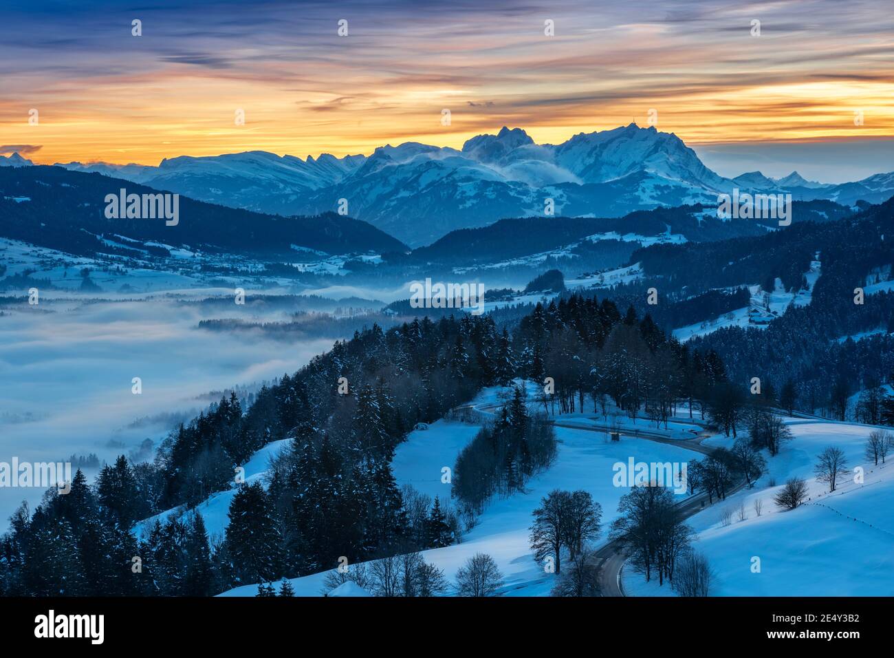 awesome winter landscape at sunset with  view from the Allgau Alps over the Bregenzer Wald in Austria to Mount Saentis in Switzerland Stock Photo