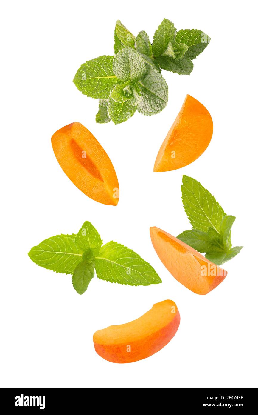 Falling down mint herb and apricots isolated on white background Stock Photo