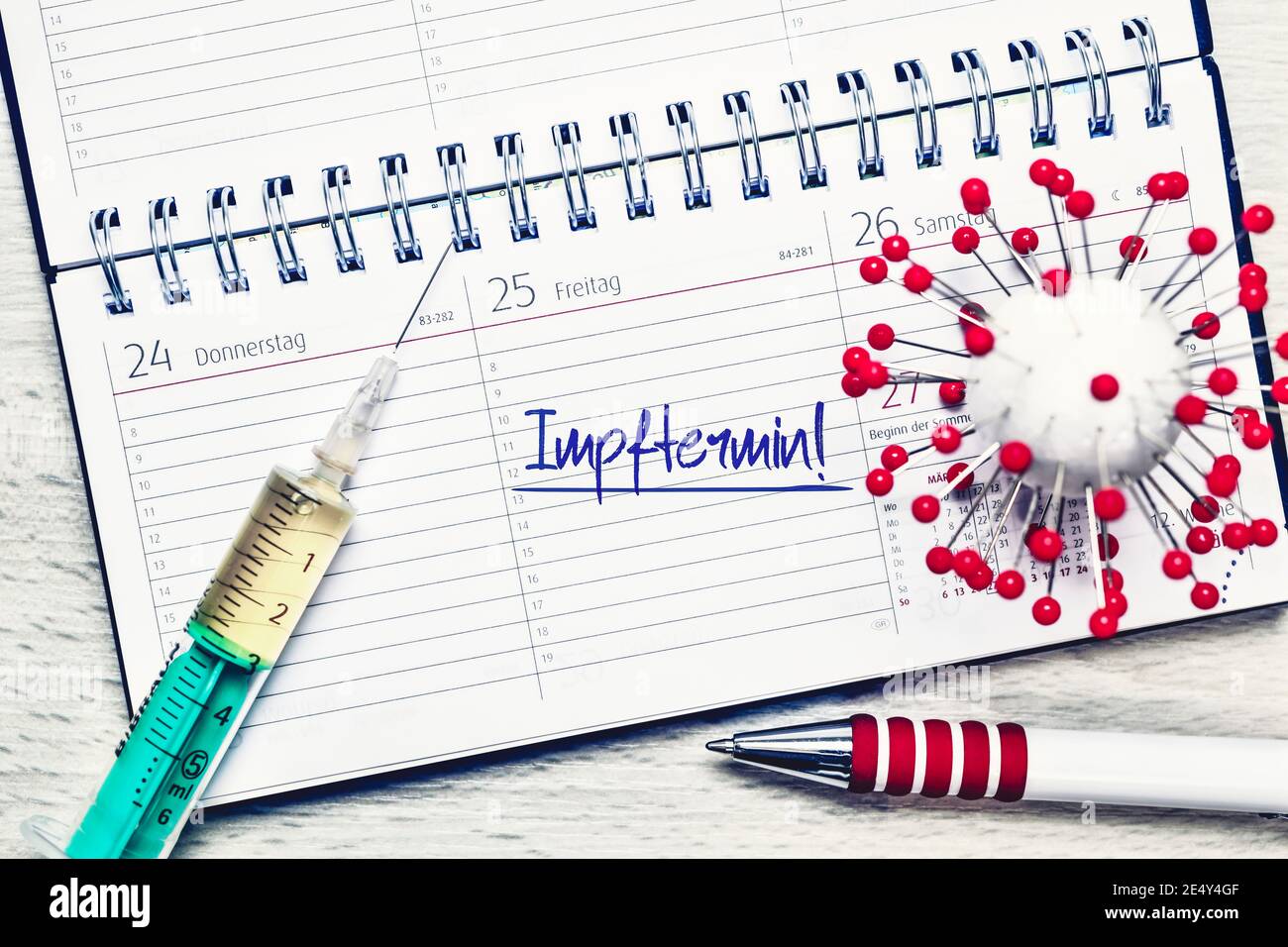 Coronavirus Model And Syringe On Calendar, Date Of Vaccination Stock Photo