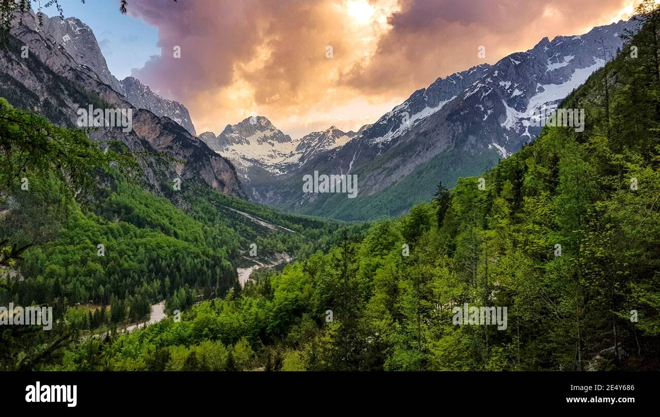 Amazing Range Amazing sky above mountain range. Clouds, sunset in Trenta valley ...