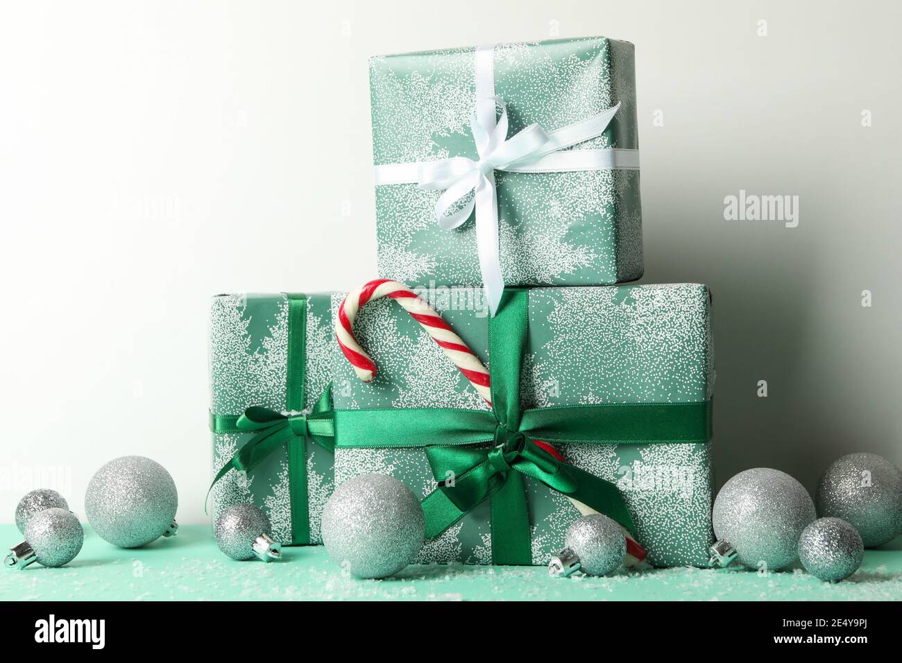 Gift boxes, candy cane and baubles on white background Stock Photo - Alamy