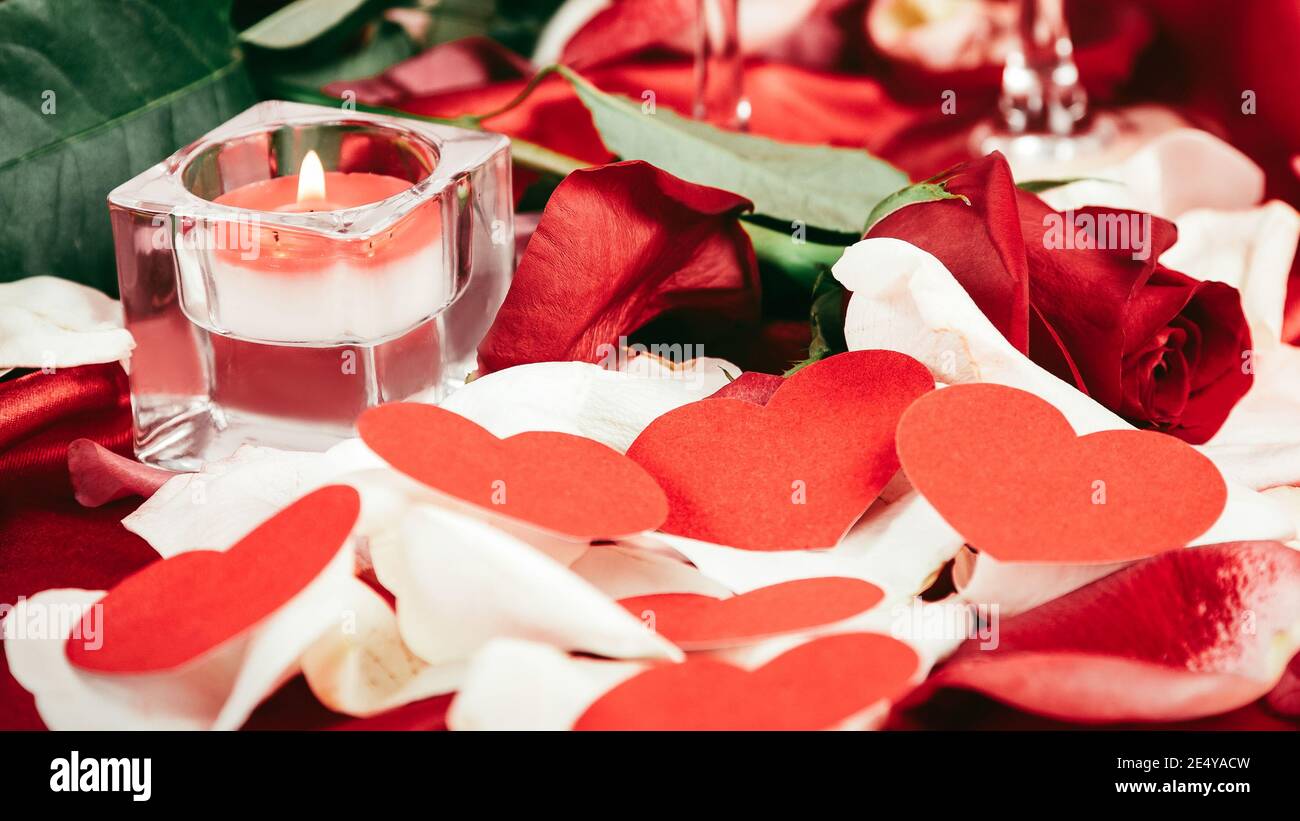 candle and rose petals on a festive background Stock Photo - Alamy