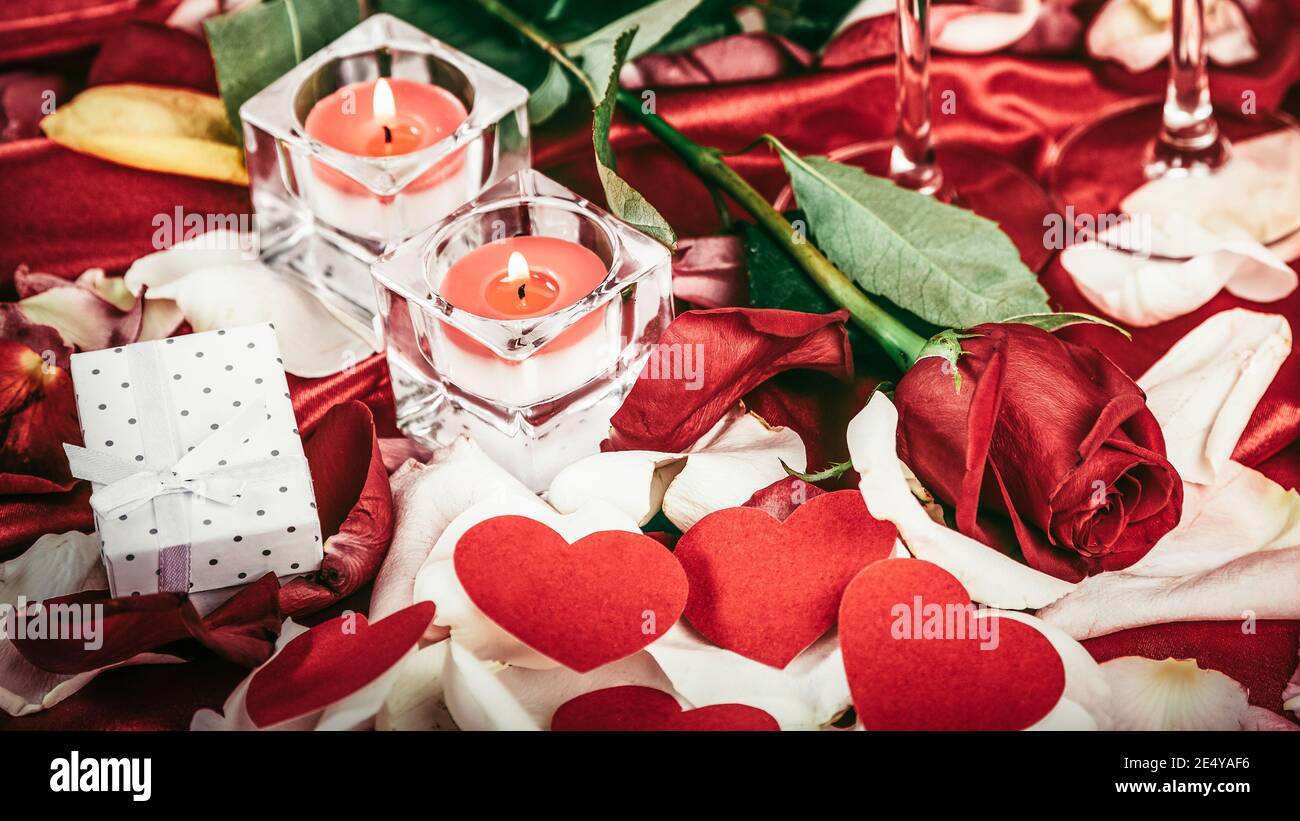 candle and rose petals on a festive background Stock Photo - Alamy