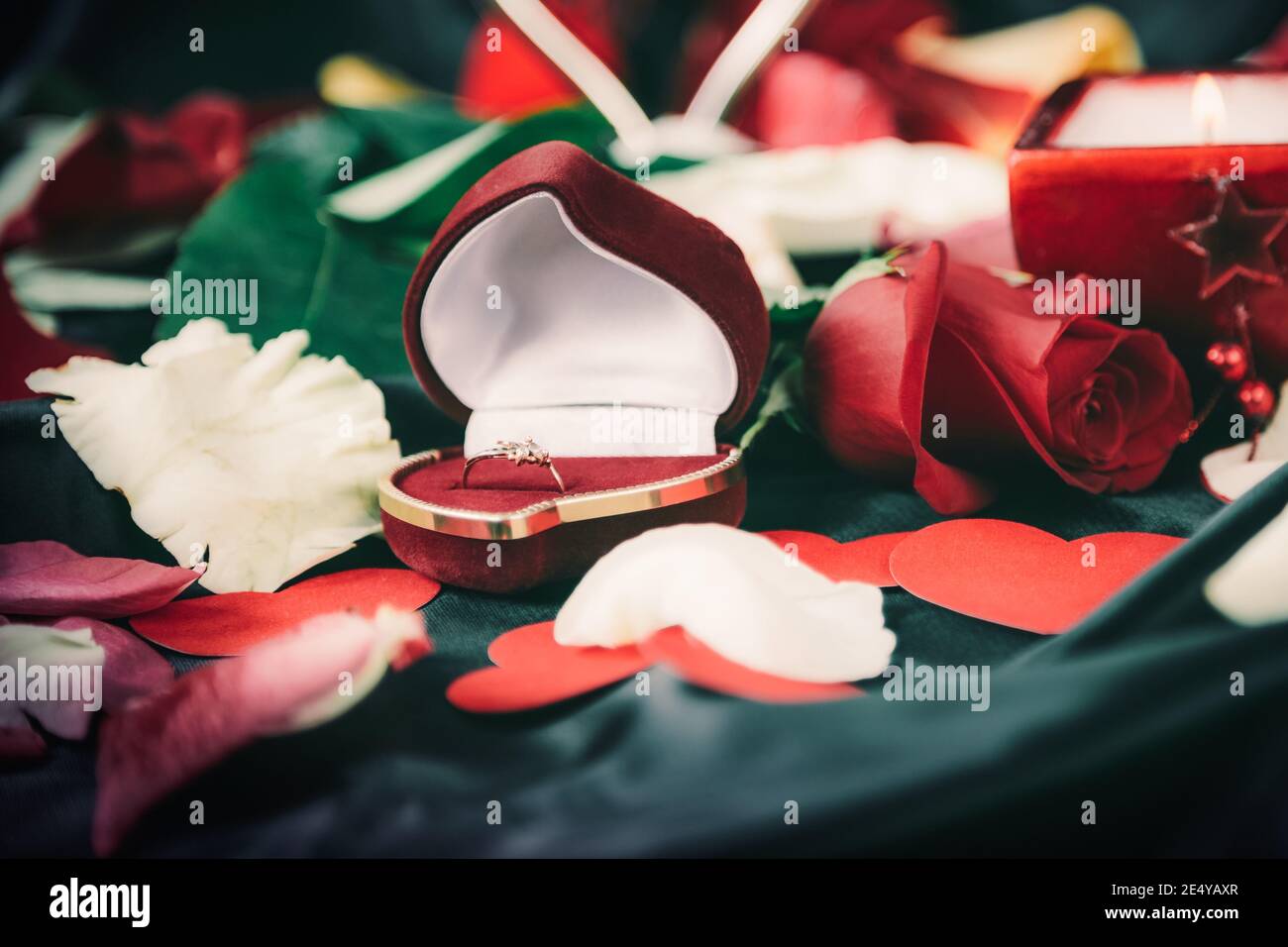 box with ring and rose petals in black silk background Stock Photo - Alamy