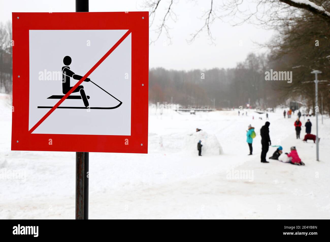 No sledding sign in the snowy park. Children safety during winter holidays Stock Photo