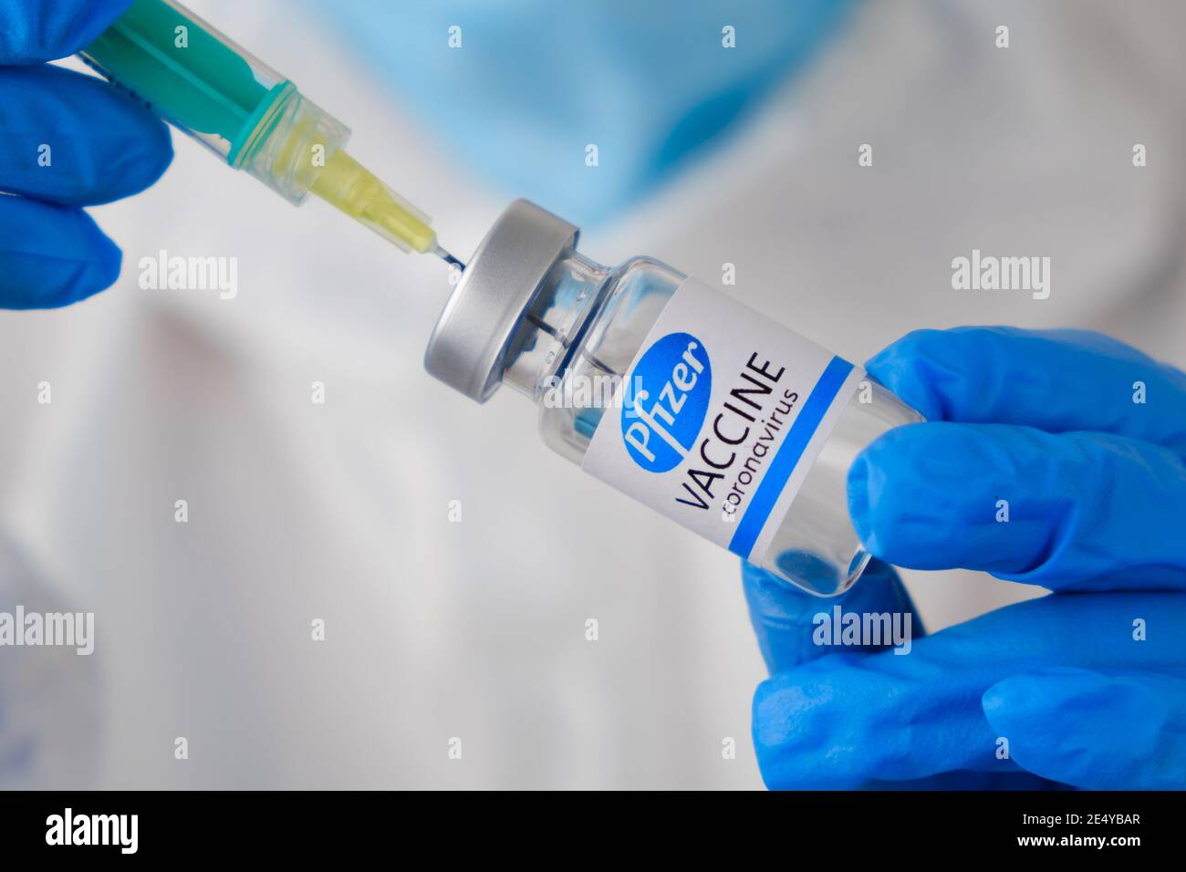 Pfizer coronavirus Vaccine and syringe in the bottle or vial for injection in doctors hands. Covid-19, SARS-Cov-2 prevention, January 2021, San Stock Photo