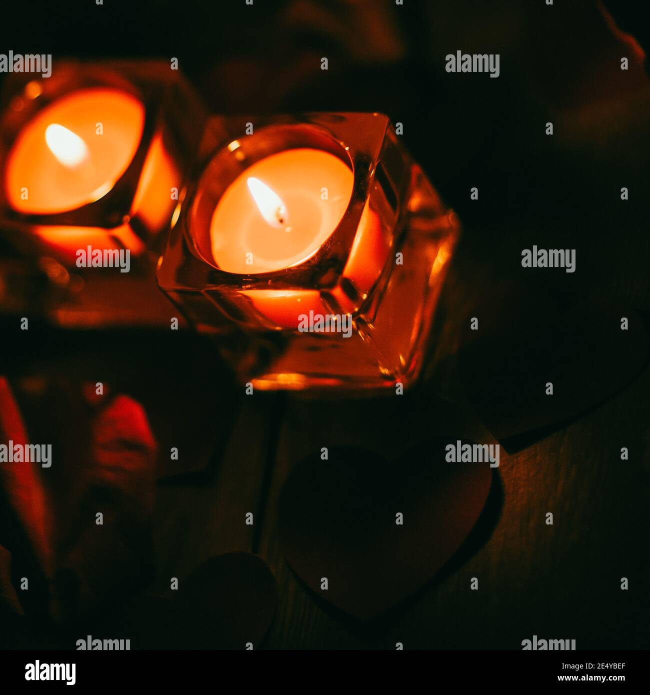 two burning candles on a dark background Stock Photo