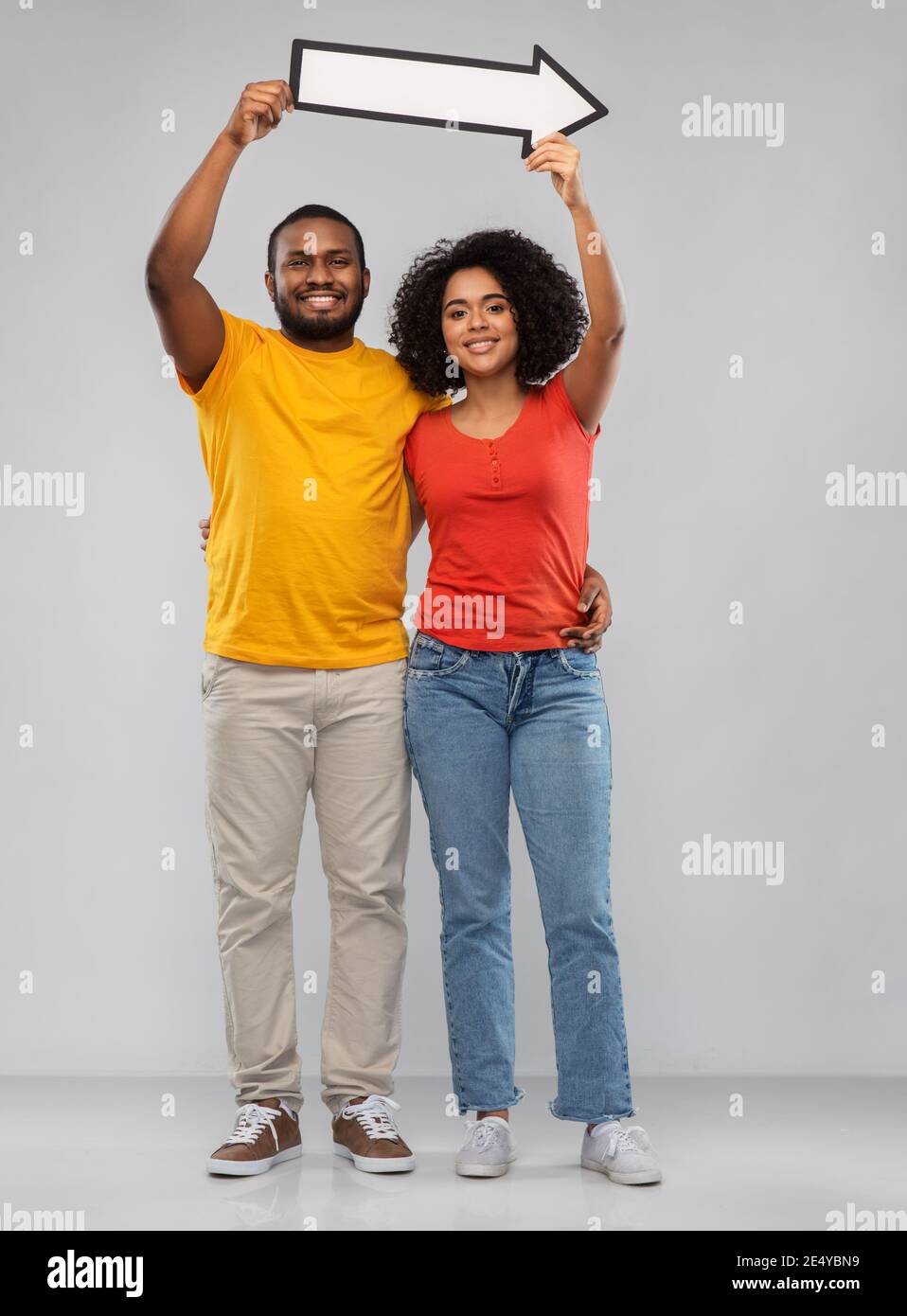 happy african american couple holding arrow Stock Photo - Alamy