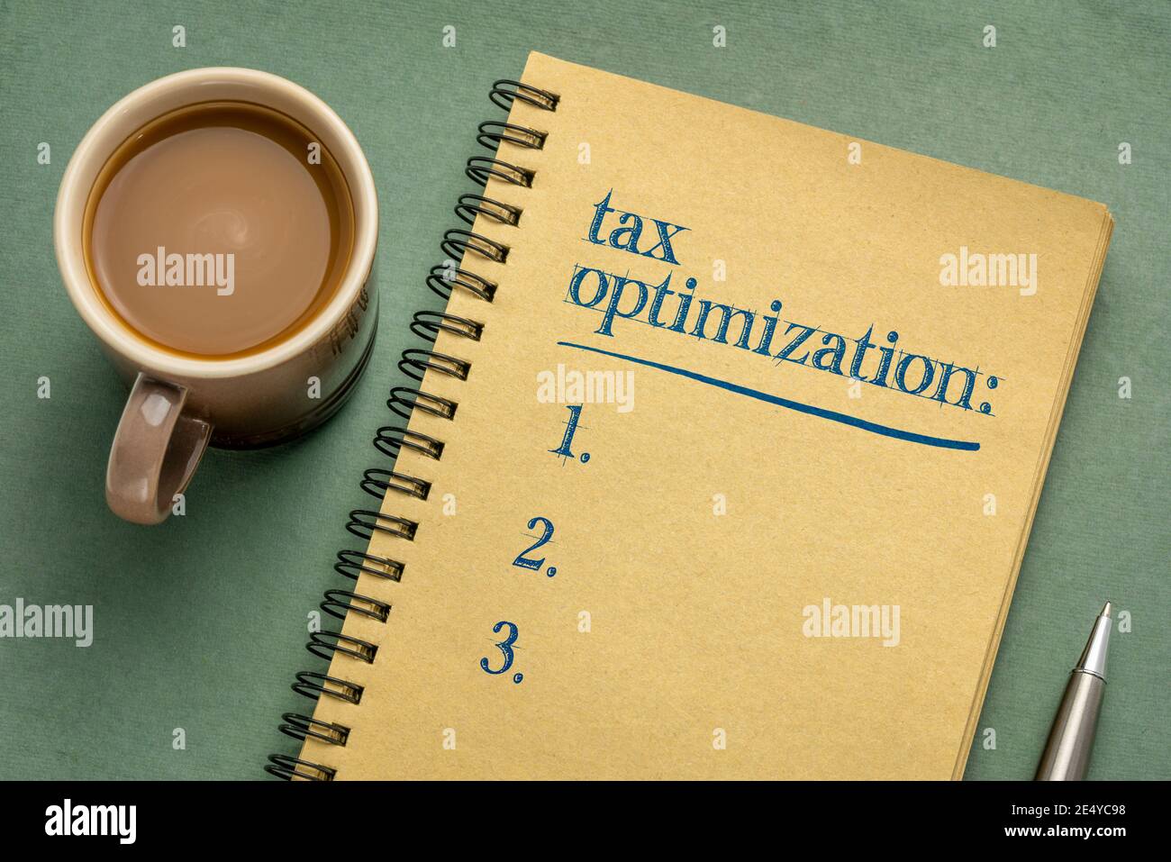 tax optimization list - handwriting in a notebook with a cup of coffee, business and finance planning concept Stock Photo