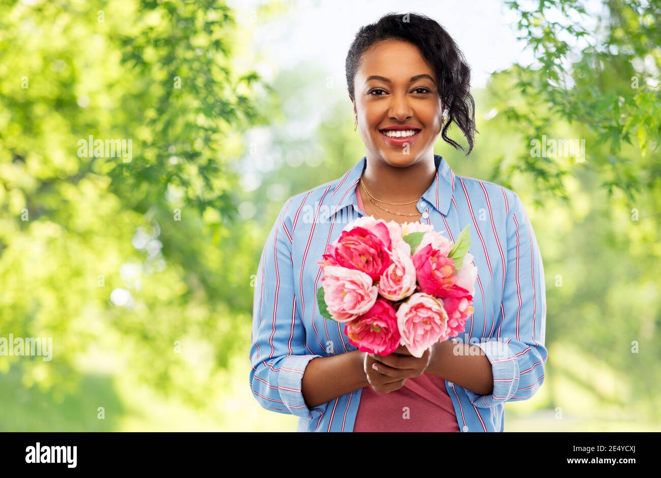 happy african american woman with bunch of flowers Stock Photo - Alamy
