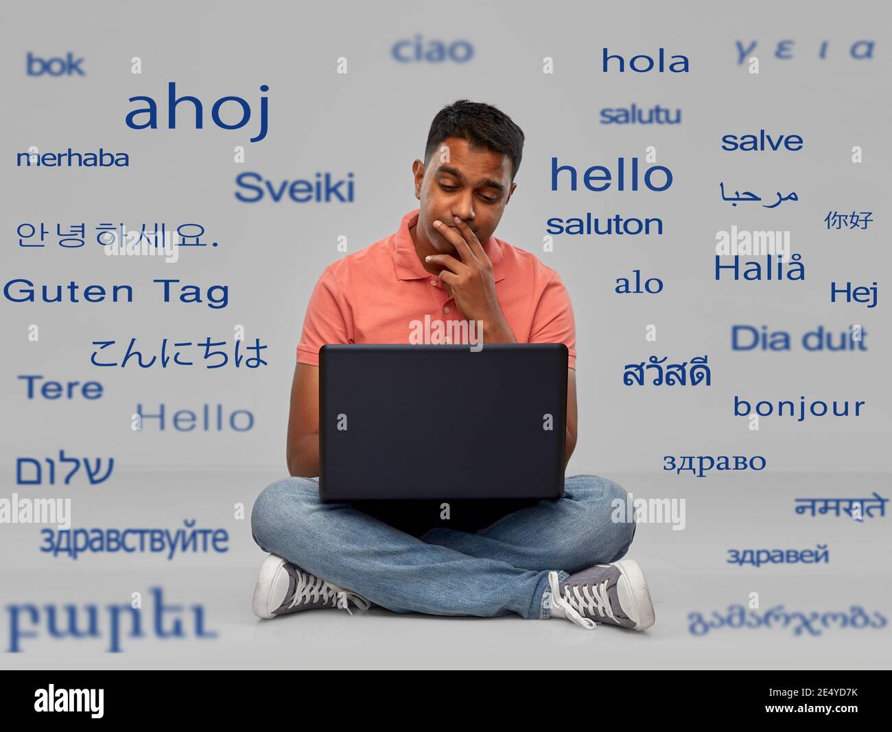 thinking indian man with laptop computer Stock Photo