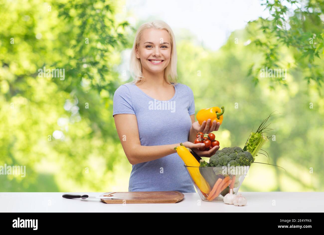 cooking and food concept - smiling female chef chopping vegetables ...