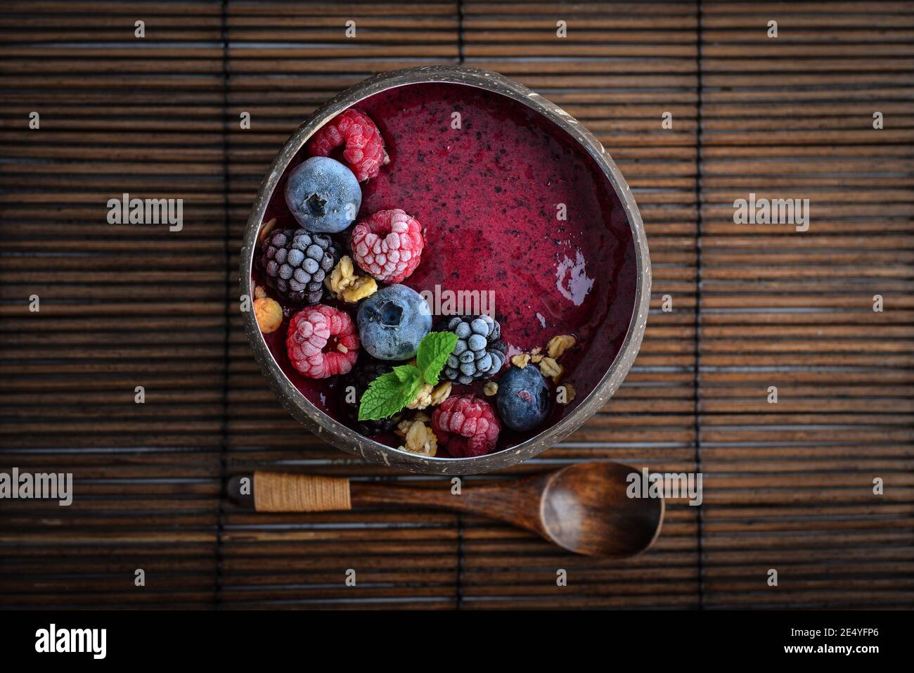 Acai smoothie bowl with blueberry, blackberry, raspberry, granola and chia seeds in bowl from