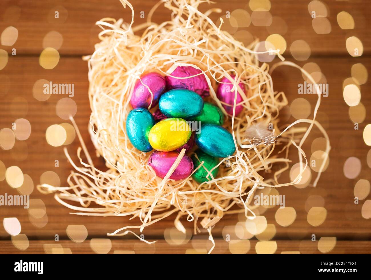 chocolate easter eggs in straw nest on table Stock Photo - Alamy