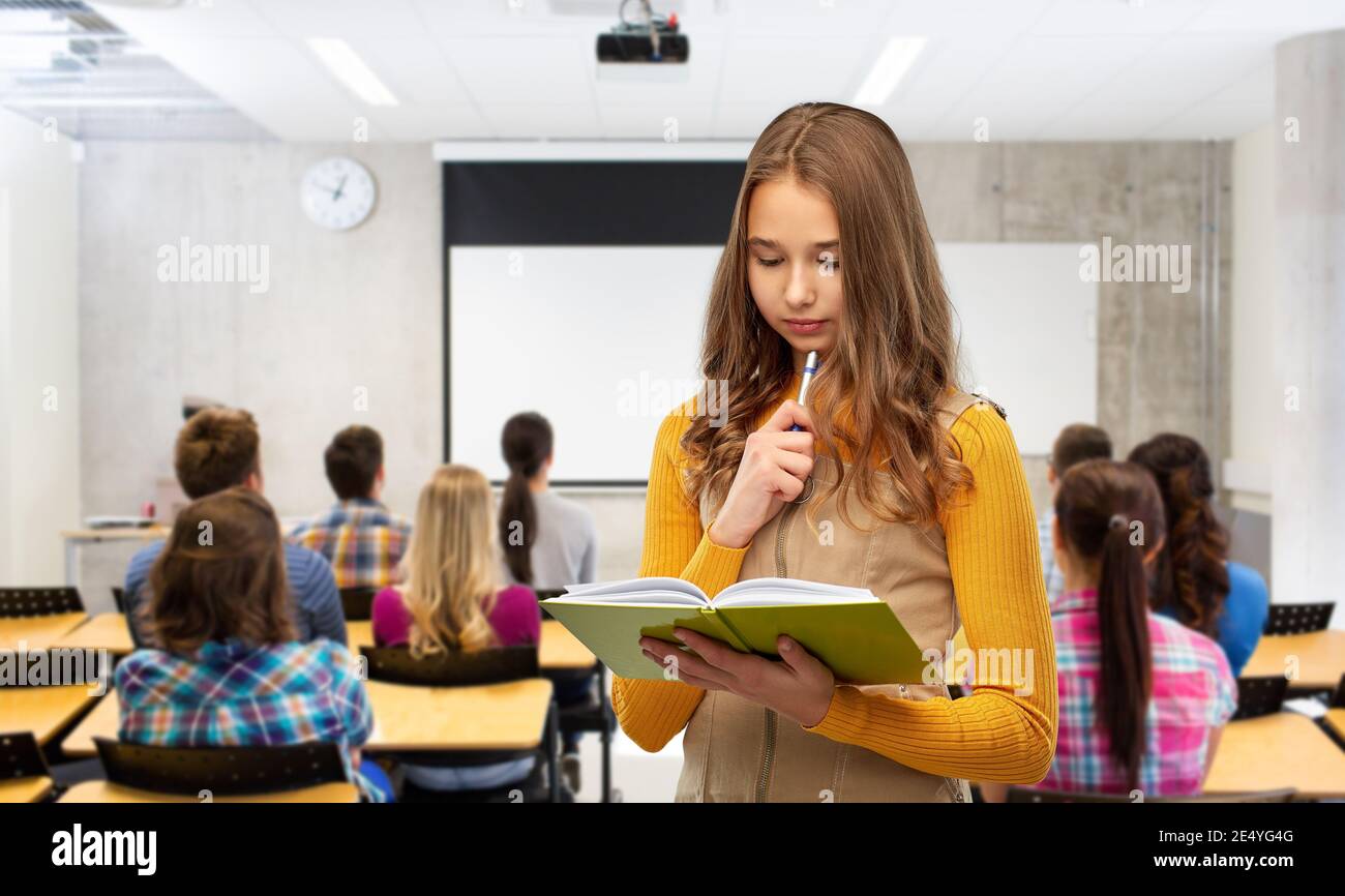 student girl with book and pen at library Stock Photo - Alamy