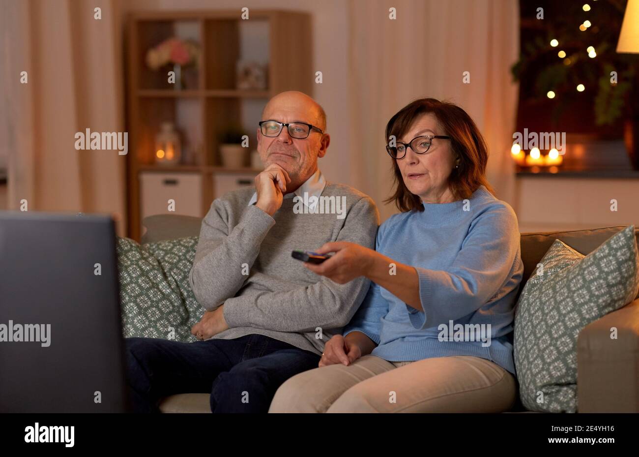 senior couple watching tv at home in evening Stock Photo