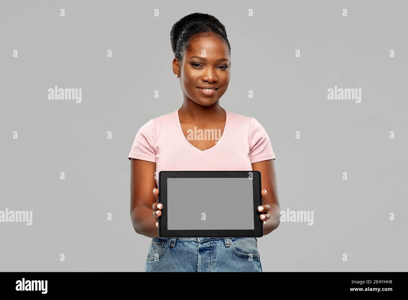 happy african american woman showing tablet pc Stock Photo - Alamy