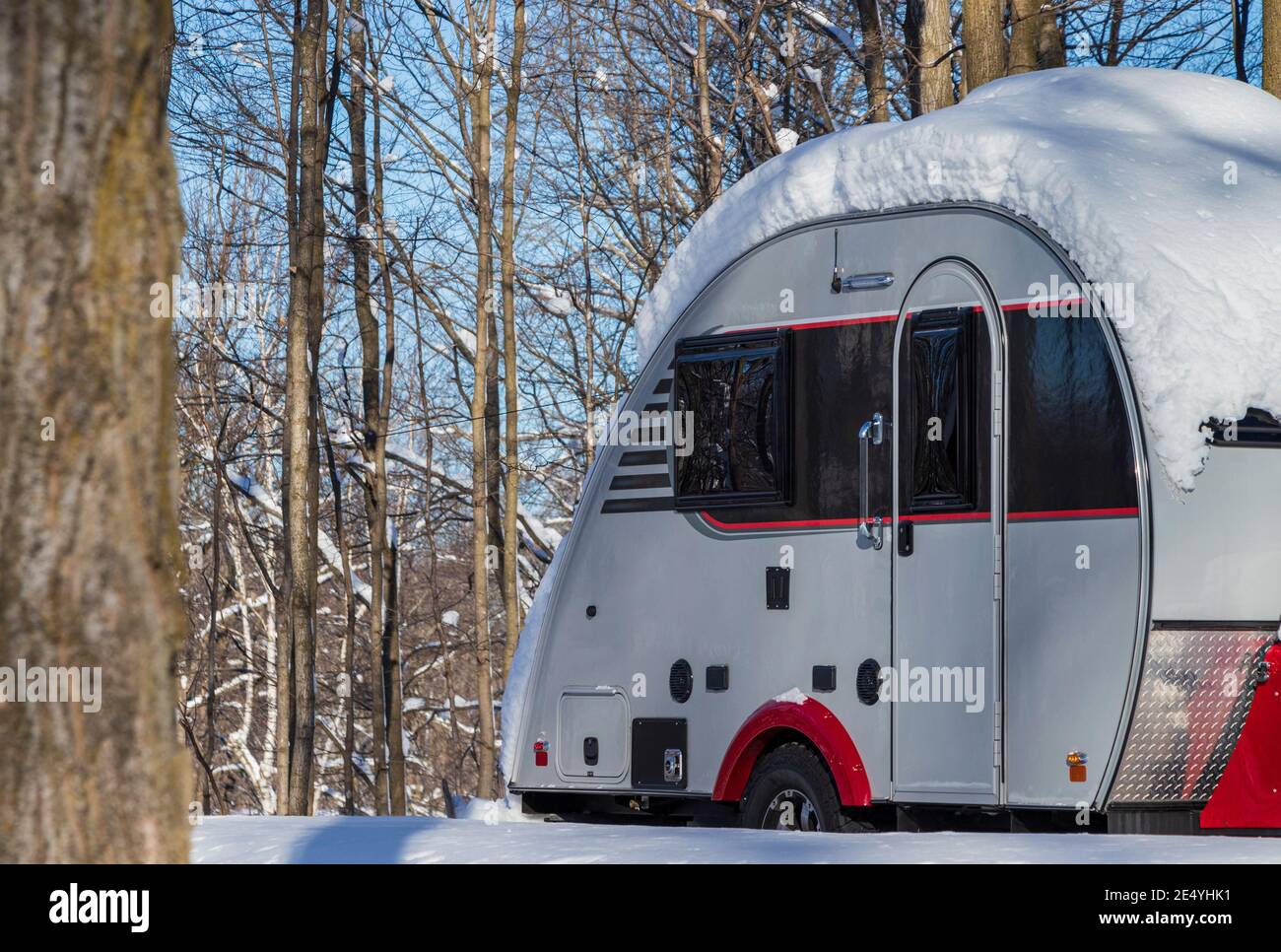 A Teardrop travel trailer on a campsite during winter season, storage, winterize Stock Photo
