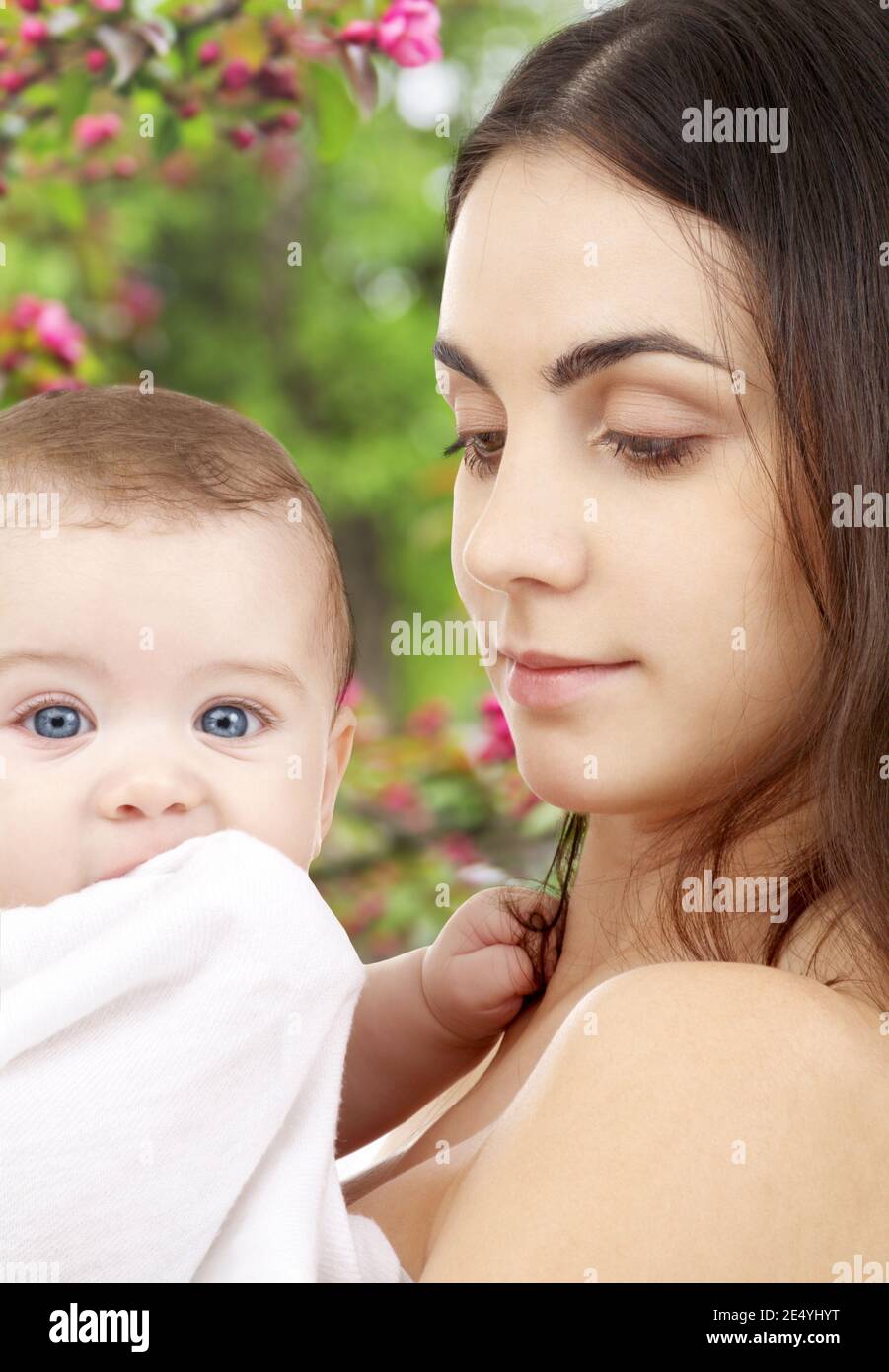 mother with baby over spring garden background Stock Photo - Alamy