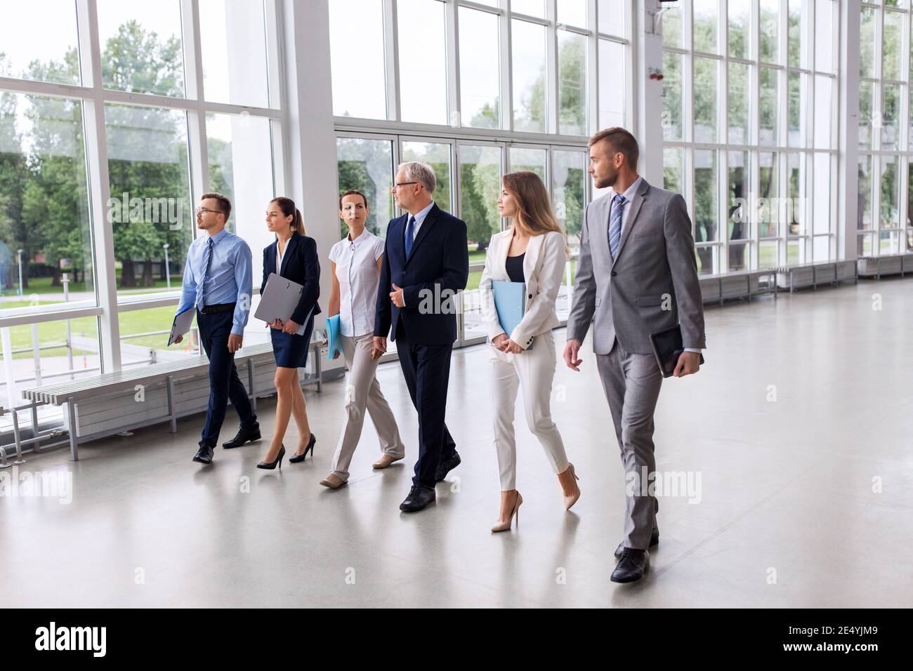 business people walking along office building Stock Photo - Alamy