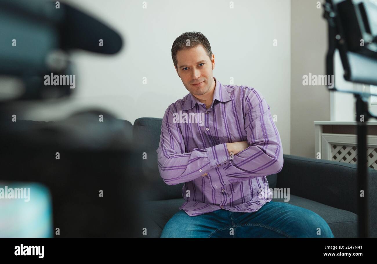 Handsome man recording his videoblog at home. Stock Photo