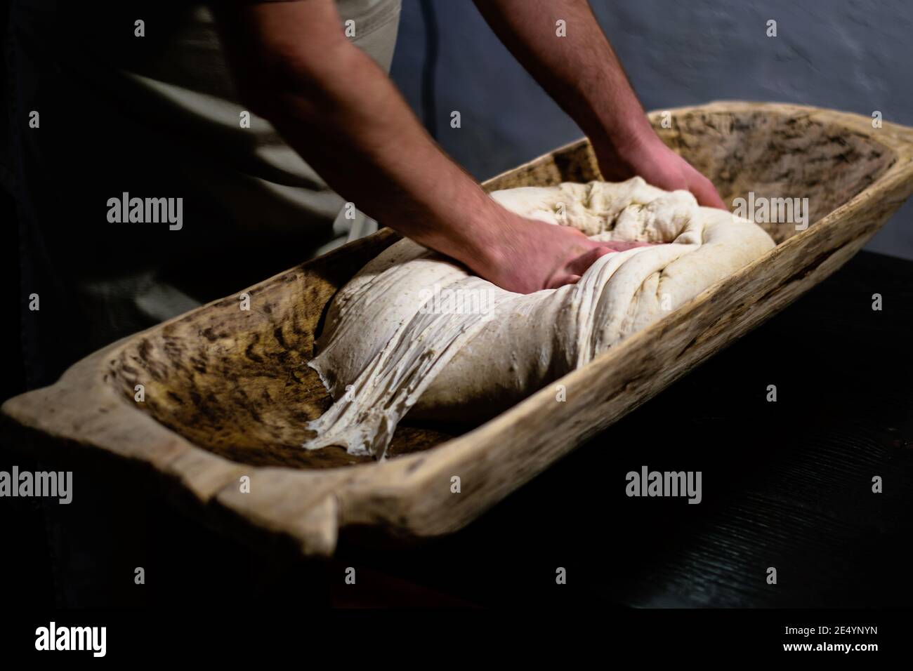 https://c8.alamy.com/comp/2E4YNYN/kneading-dough-for-the-oven-in-a-traditional-wooden-bread-trough-2E4YNYN.jpg