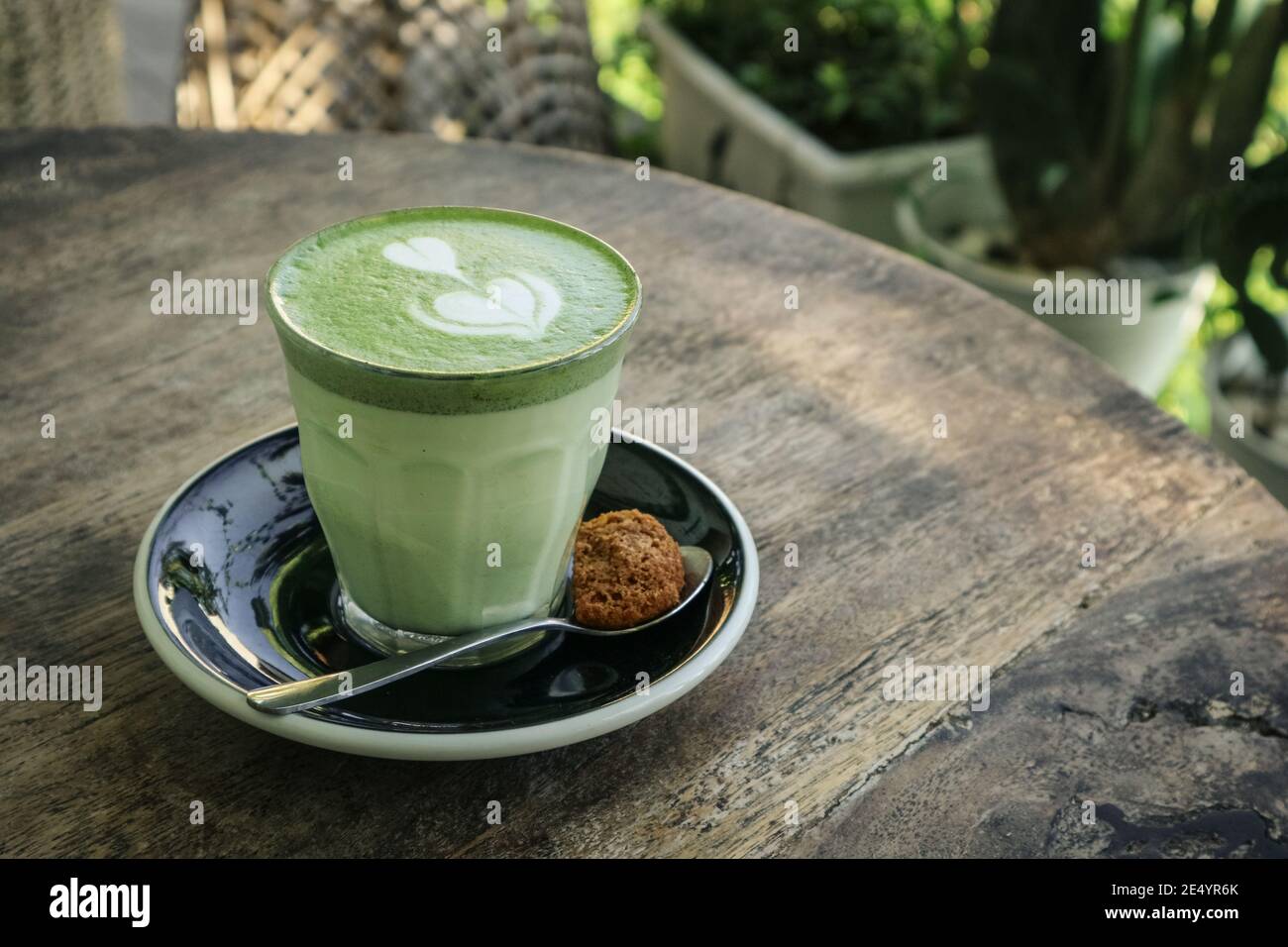 Matcha latte with latte art on top on a wooden background closeup Stock Photo