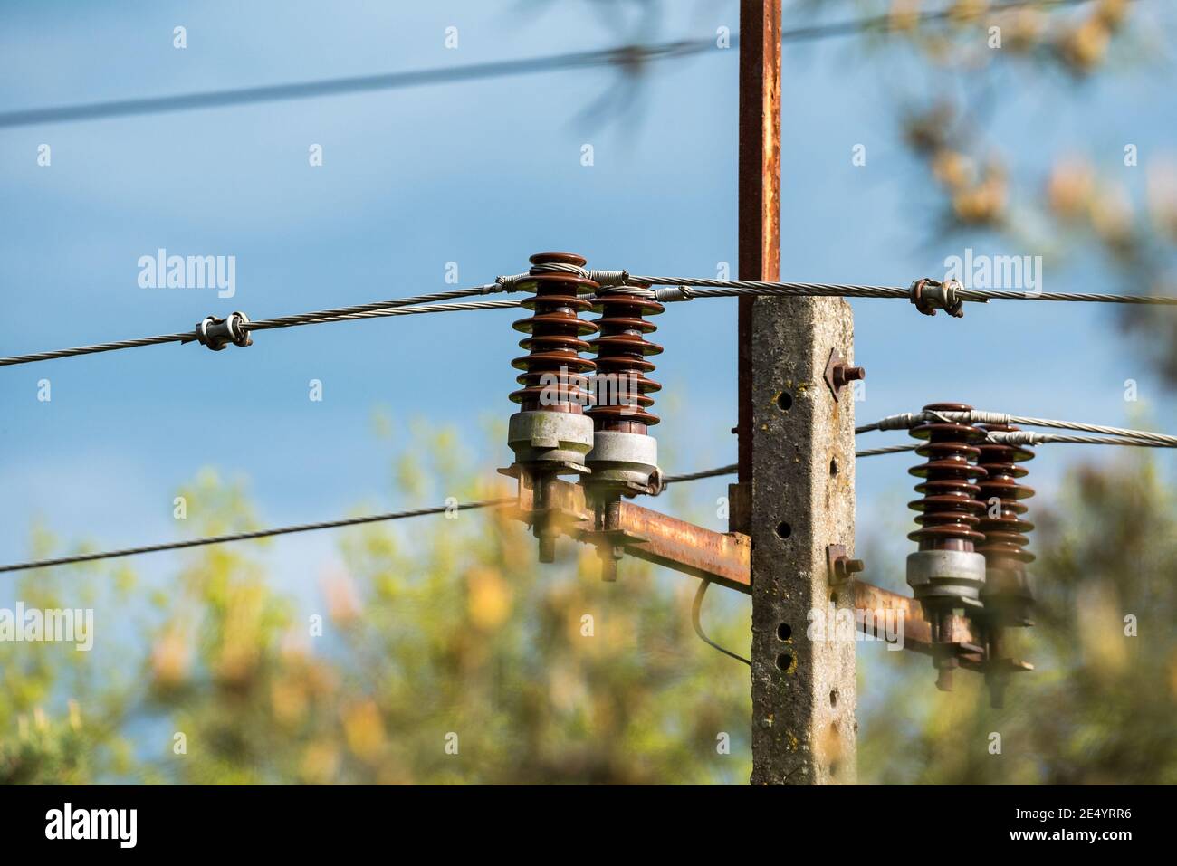 Power line with live wires. Electric poles with ceramic cable