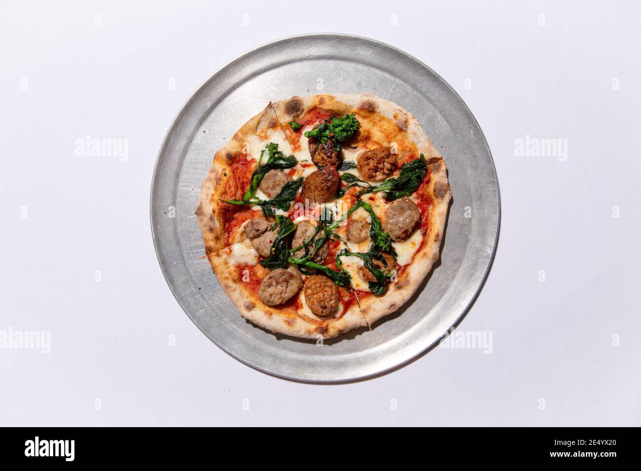 High Angle View of Brick Oven Pizza with Sausage and Broccoli Raab Stock Photo