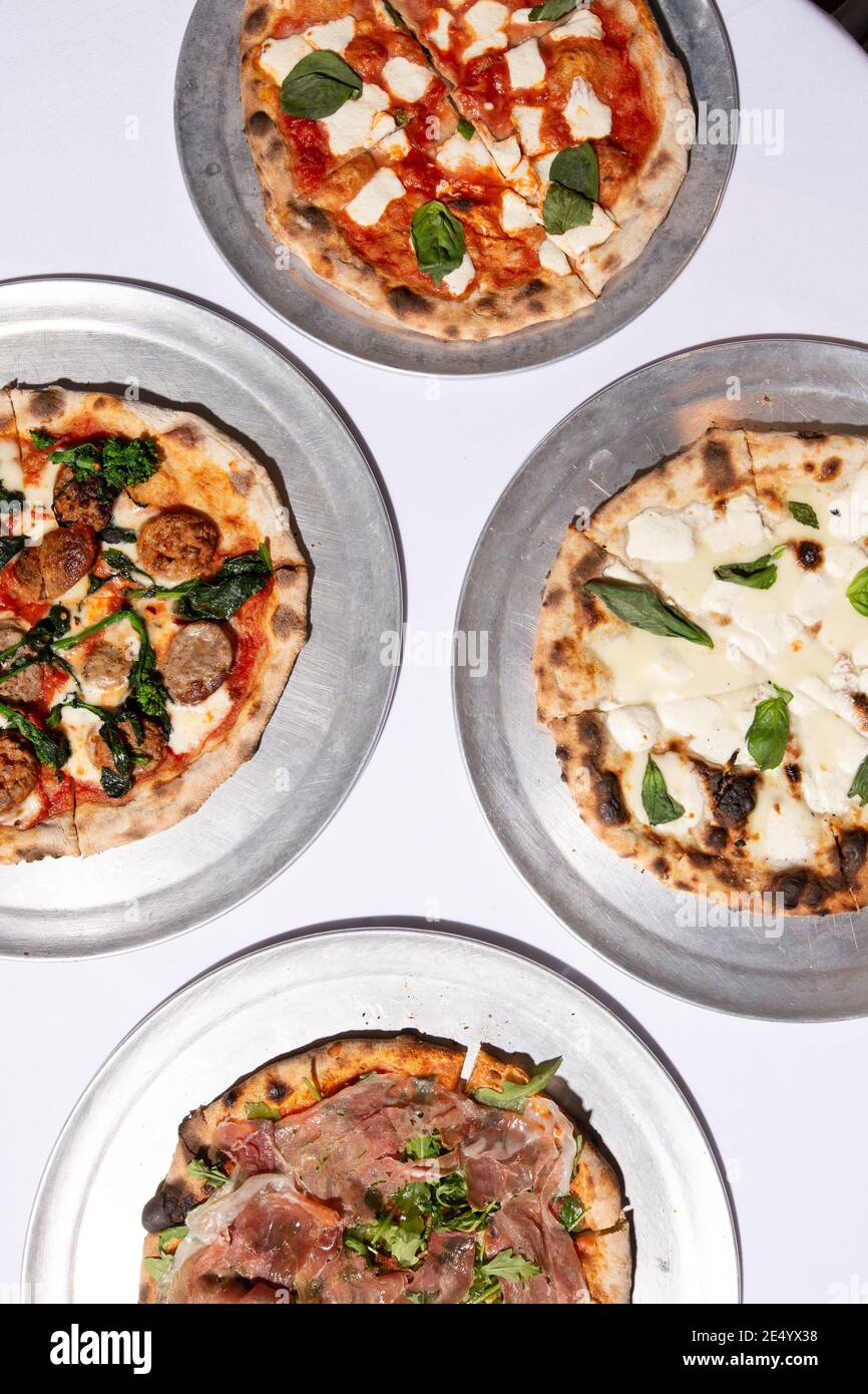 High Angle View of Four Brick Oven Pizzas Stock Photo