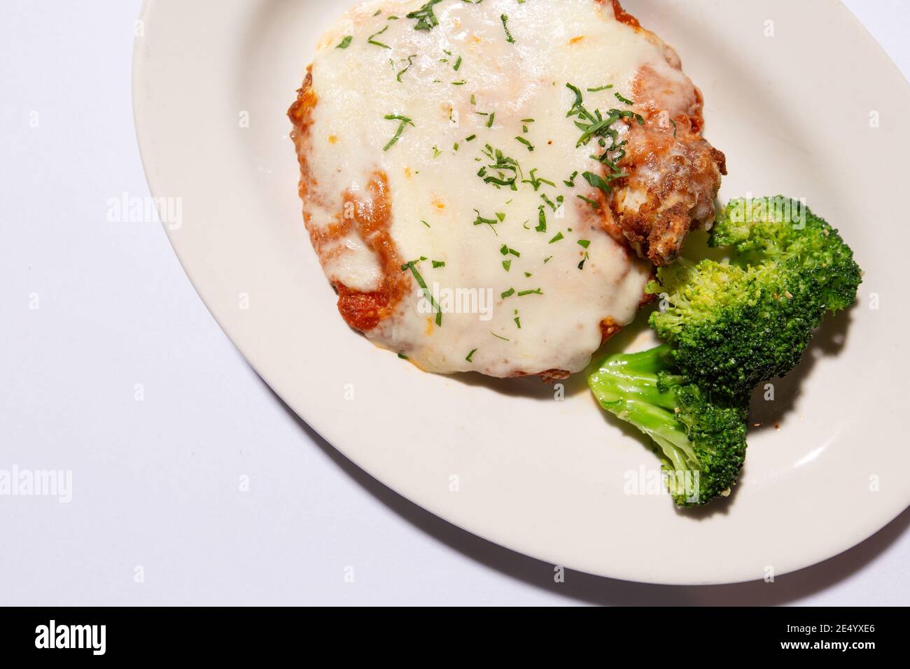 High Angle View Crop of Veal Parmesan with Broccoli Stock Photo