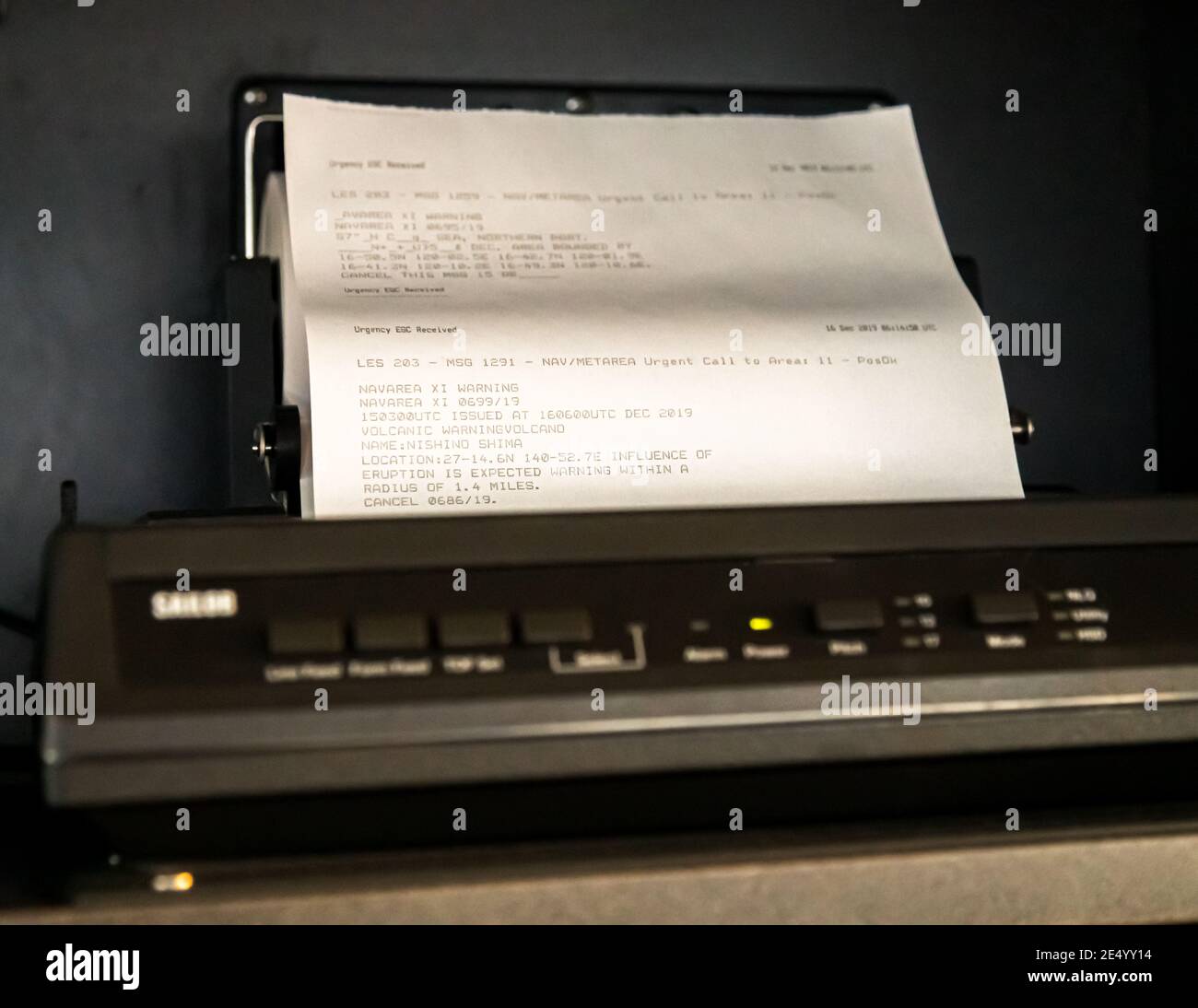 Fax machine on board a ship with earthquake warning messages Stock Photo