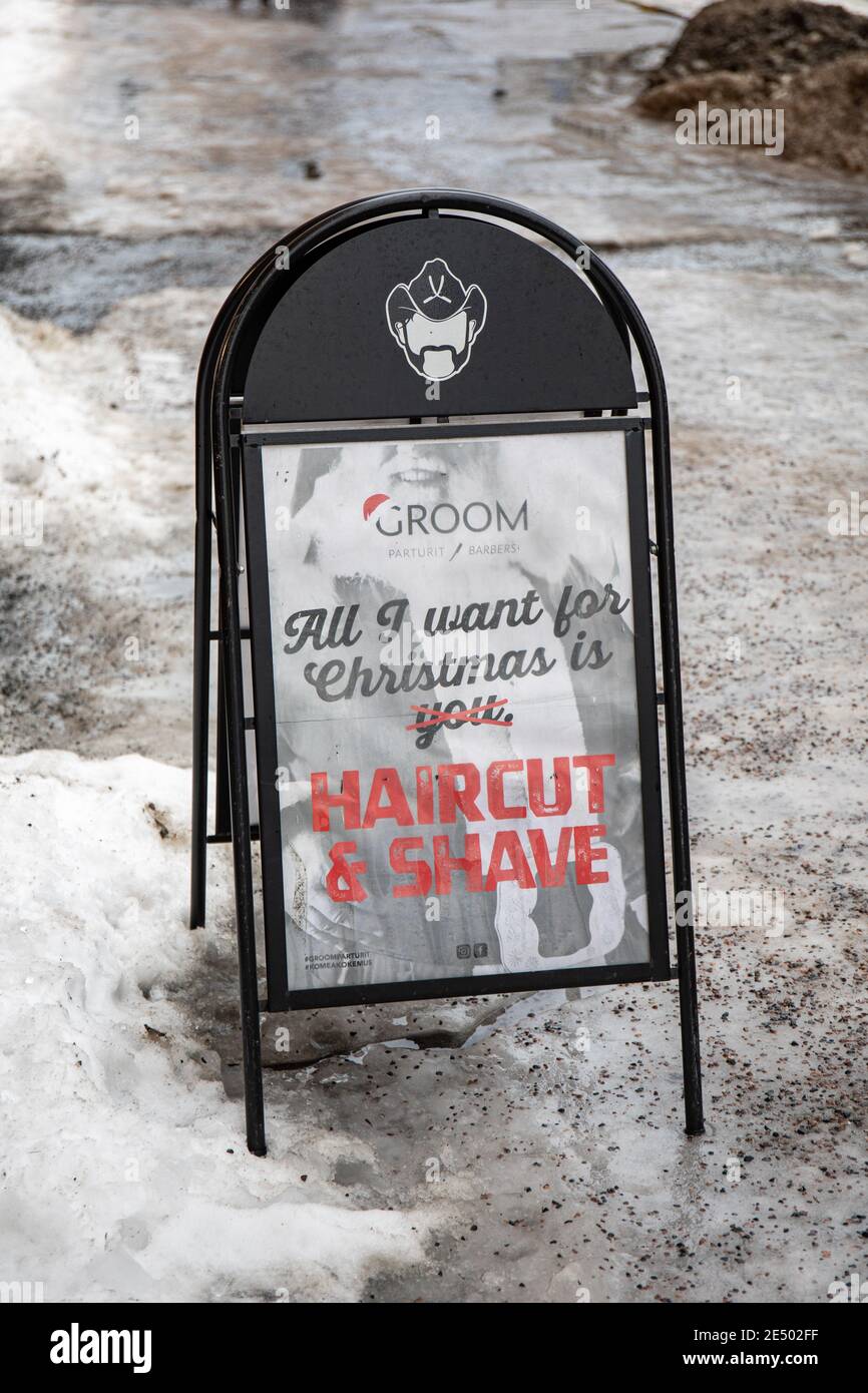 All I want for Christmas is haircut & shave. Sign on icy sidewalk in Helsinki, Finland. Stock Photo