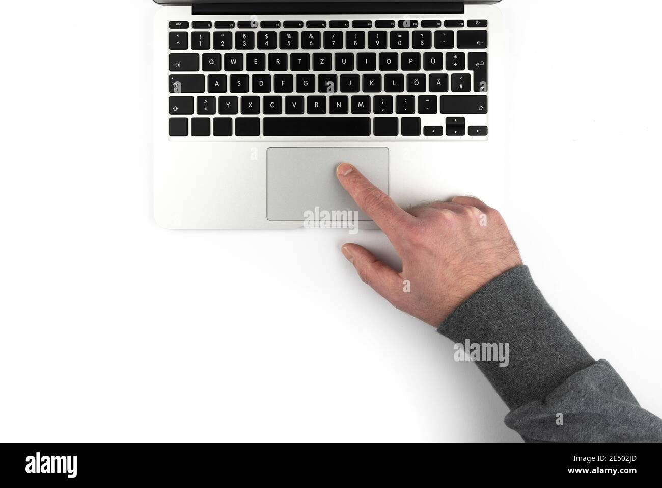 overhead view of person using touchpad or trackpad on laptop computer on white background Stock Photo