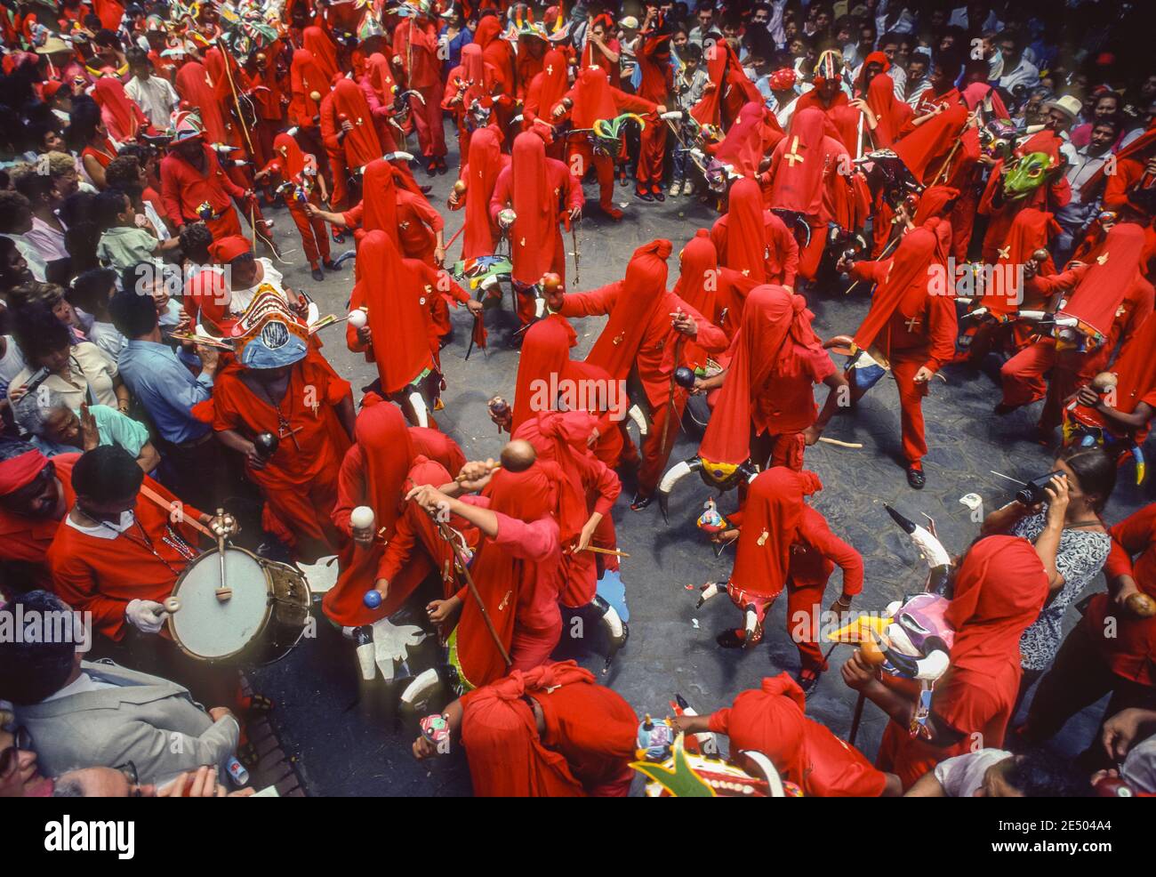 SAN FRANCISCO DE YARE, MIRANDA STATE, VENEZUELA, 1988 - Devil dancers in costumes with masks during Corpus Christi Day, a religious festival celebration in the streets. Stock Photo