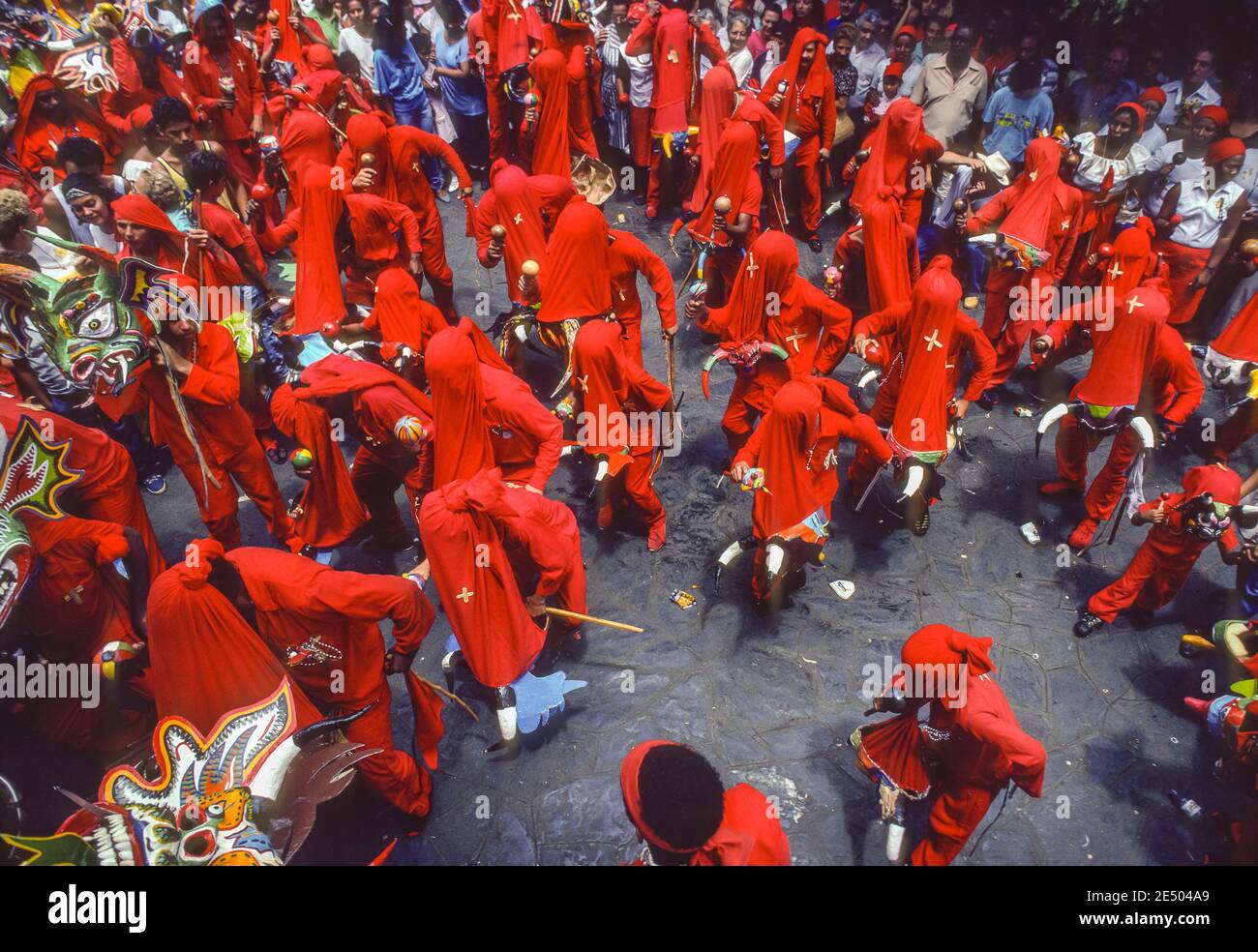 SAN FRANCISCO DE YARE, MIRANDA STATE, VENEZUELA, 1988 - Devil dancers in costumes with masks during Corpus Christi Day, a religious festival celebration in the streets. Stock Photo