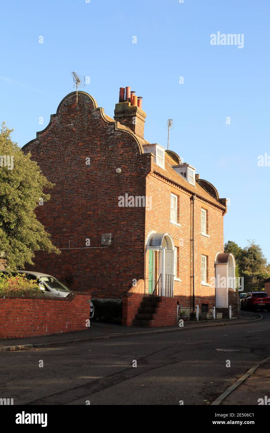 Wakely Villas in High Street, Charing, Kent, England. Pair of C18 cottages. Two storeys and basement red brick. Tiled roof with shaped Dutch gable end Stock Photo