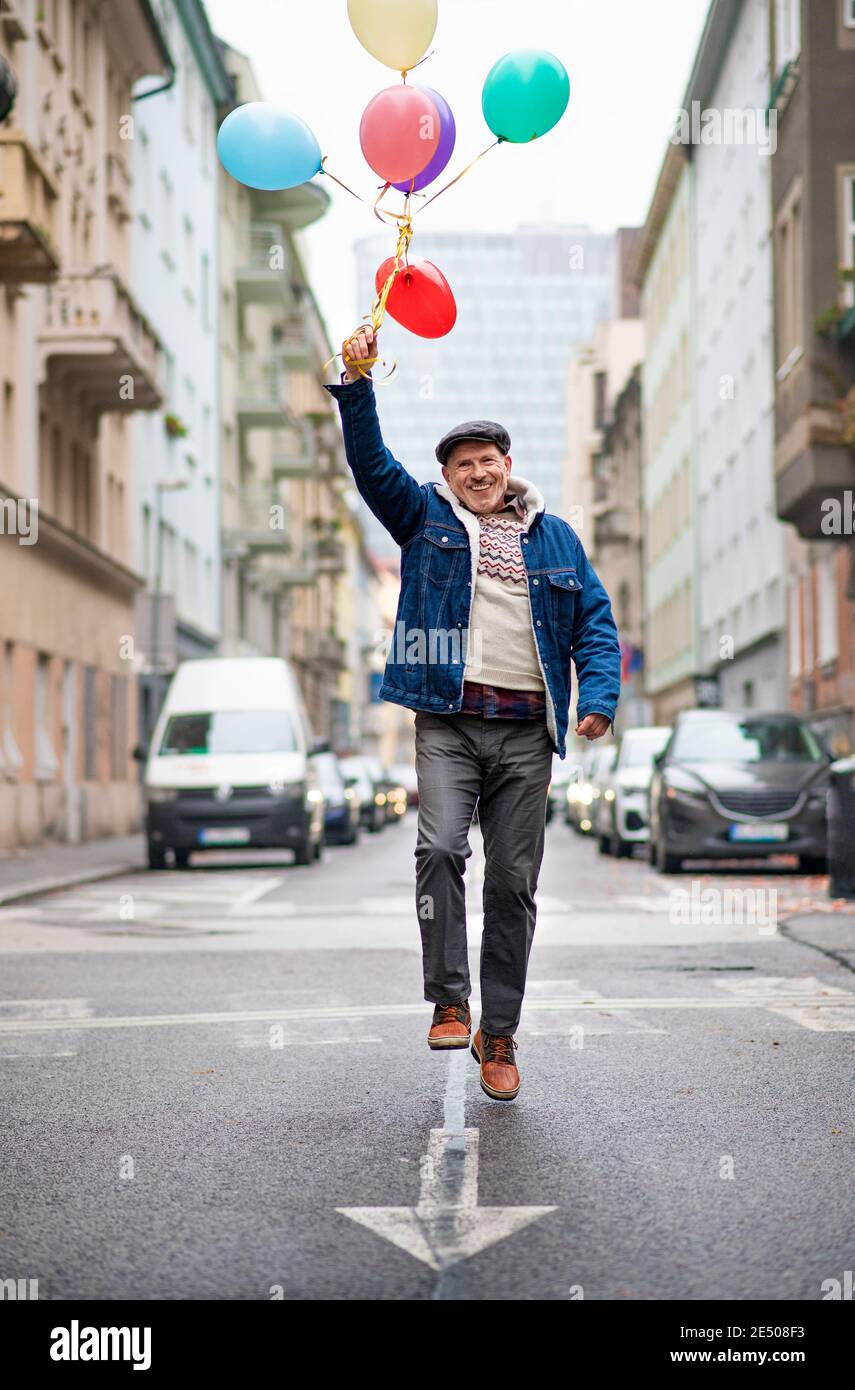 Happy senior man walking outside hi-res stock photography and images ...