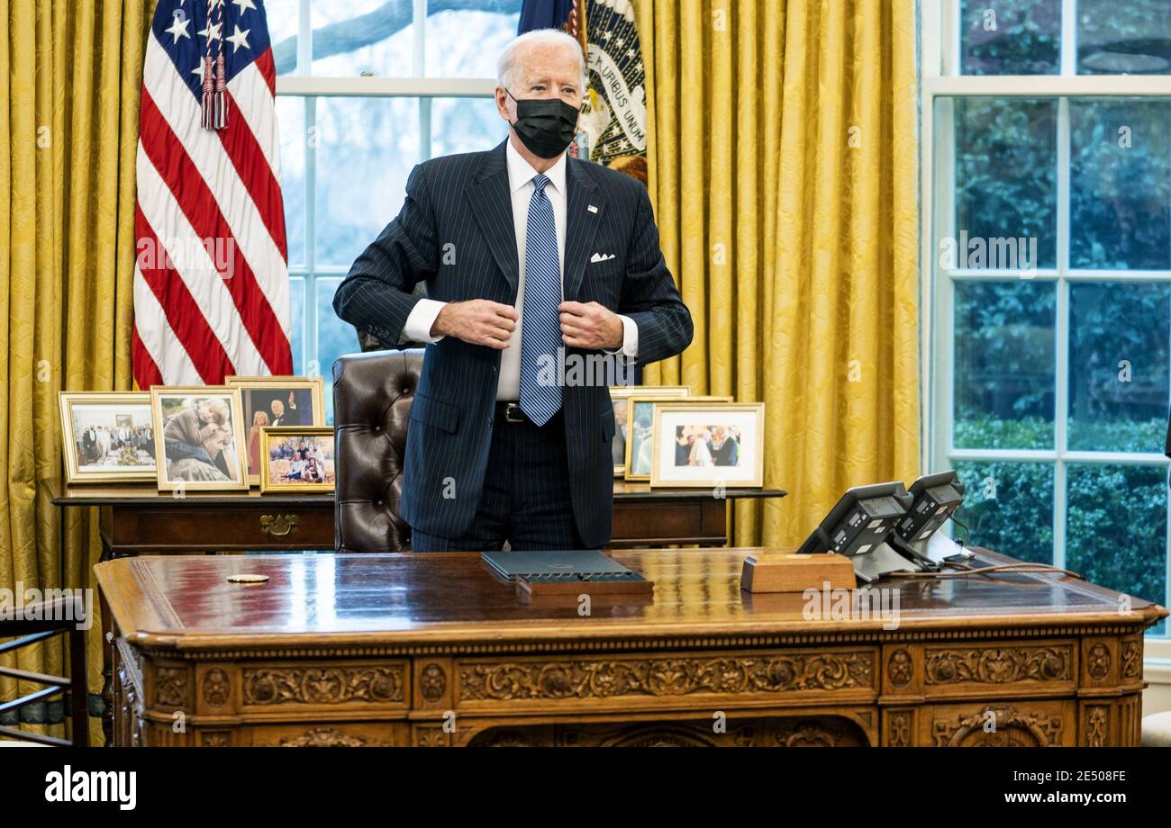 Washington, United States. 25th Jan, 2021. President Joe Biden sits as his desk to sign an executive order reversing a Trump era ban on transgender serving in the military, in the Oval Office at the White House, Monday, January 25, 2021in Washington, DC. Pool Photo by Doug Mills/UPI Credit: UPI/Alamy Live News Stock Photo