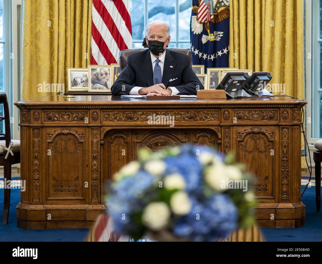 Washington, United States. 25th Jan, 2021. President Joe Biden signs an executive order reversing a Trump era ban on transgender serving in the military, in the Oval Office at the White House, Monday, January 25, 2021in Washington, DC. Pool Photo by Doug Mills/UPI Credit: UPI/Alamy Live News Stock Photo