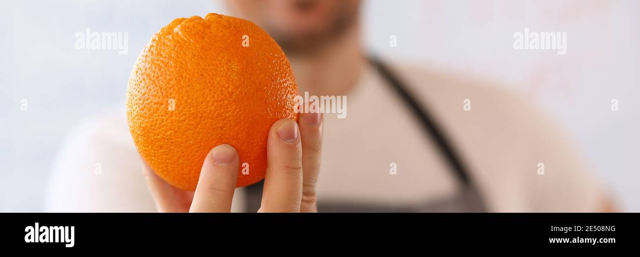Man holding fresh orange fruit hi-res stock photography and images - Alamy