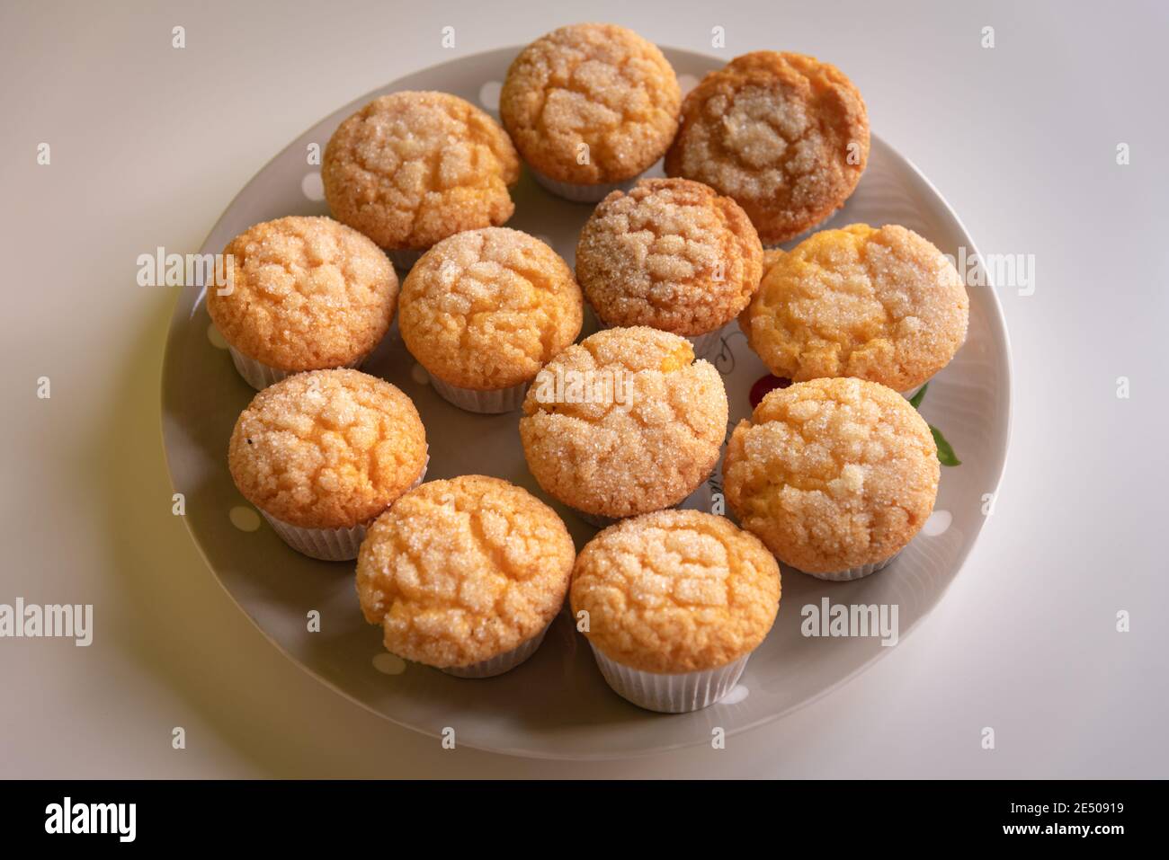 Home baked sugar coated muffins on a plate Stock Photo