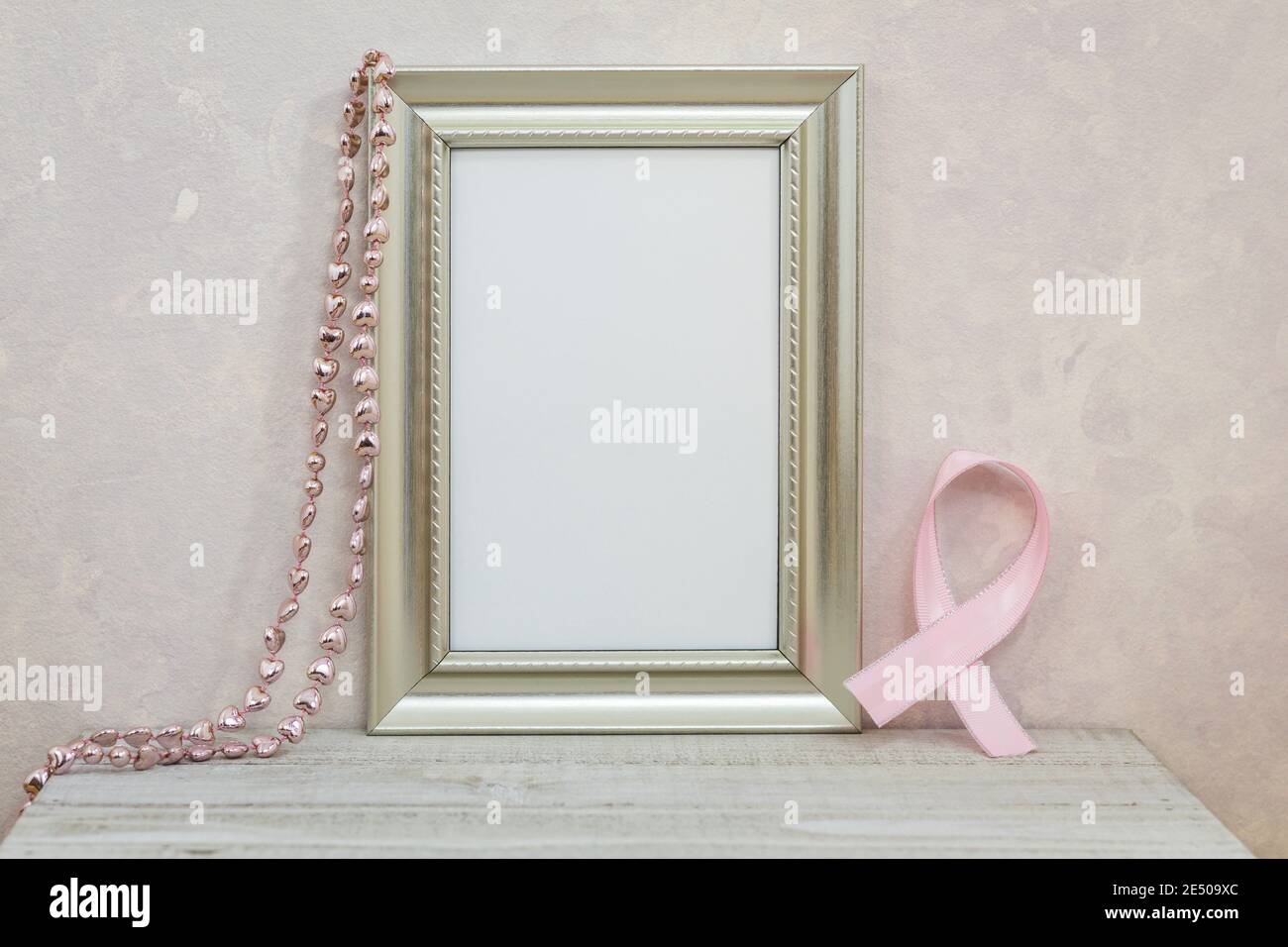 Silver Frame Mockup with pink cancer ribbon against pink textured wall ...