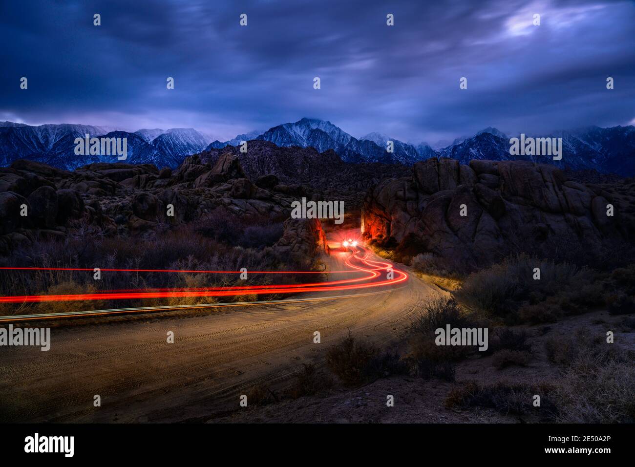 This is a picture of Alabama Hills at Night with Car Light Trail at Lone Pine, CA, USA. Stock Photo