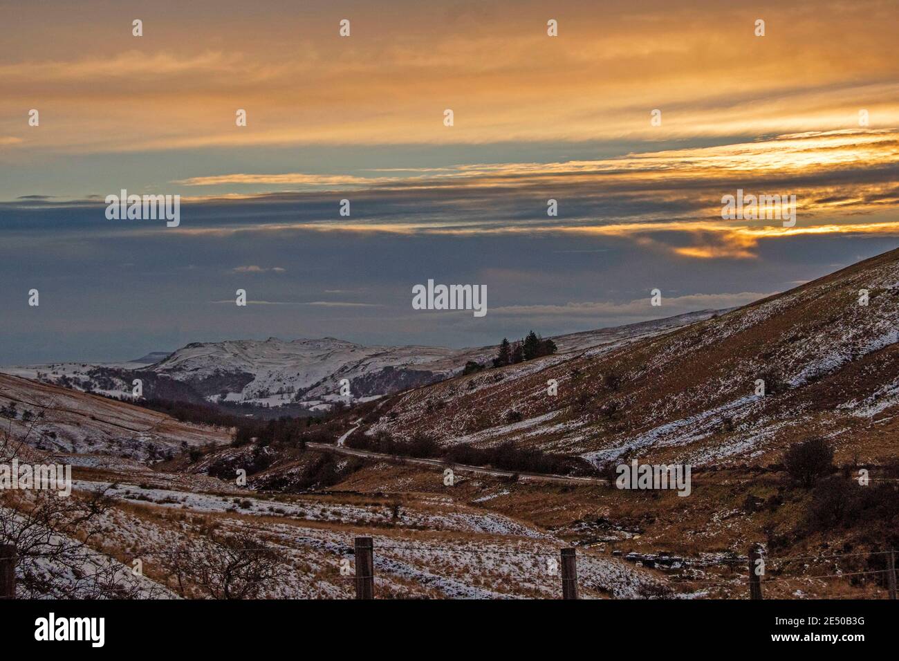 Ystradgynlais, UK. 25th Jan, 2021. The sun sets above the snowy mountains at Abercrave in the Brecon Beacons late this afternoon as the temperature starts to drop in the cold weather. Credit: Phil Rees/Alamy Live News Stock Photo